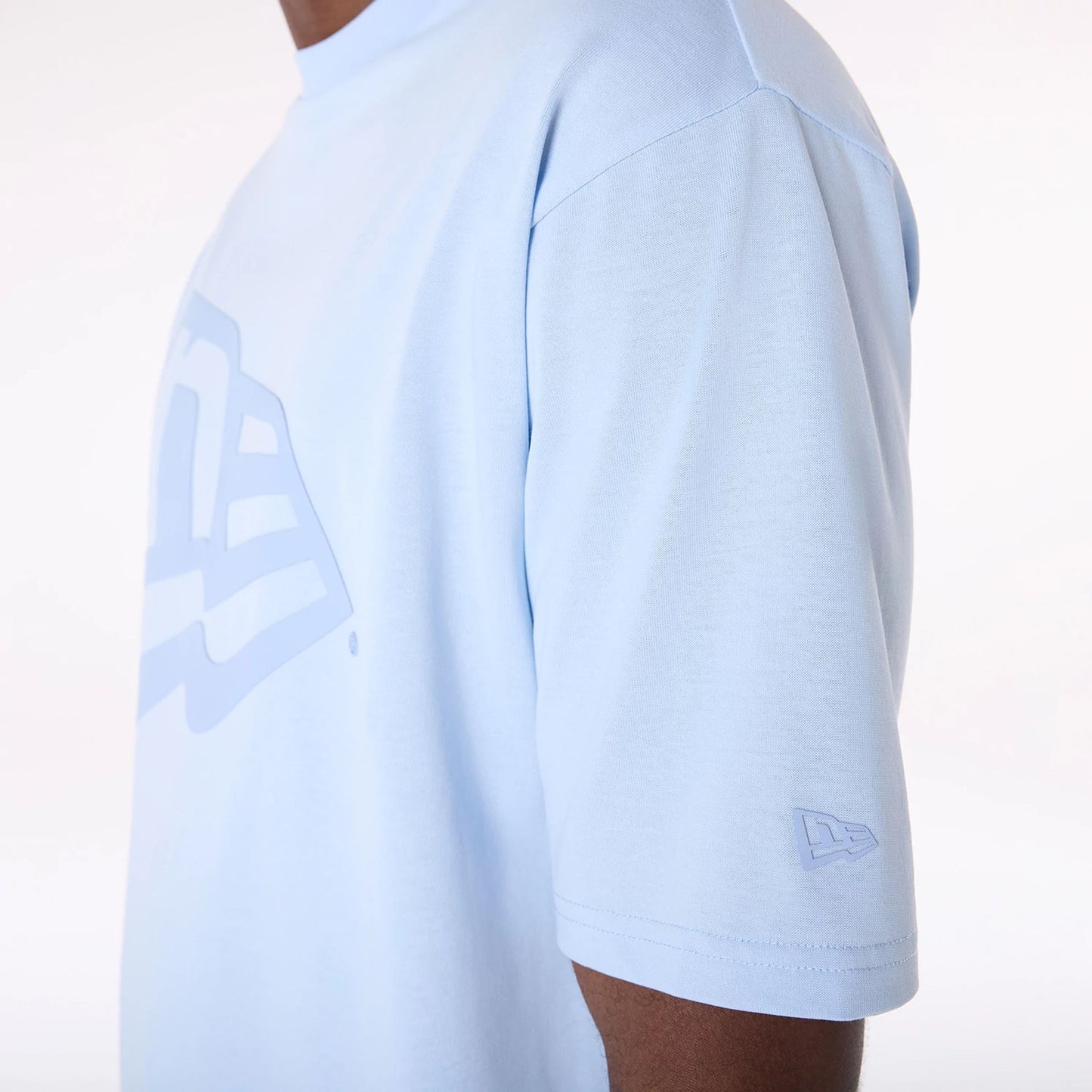 The Male model is wearing New Era Flag Pastel Blue Oversized T-Shirt 7