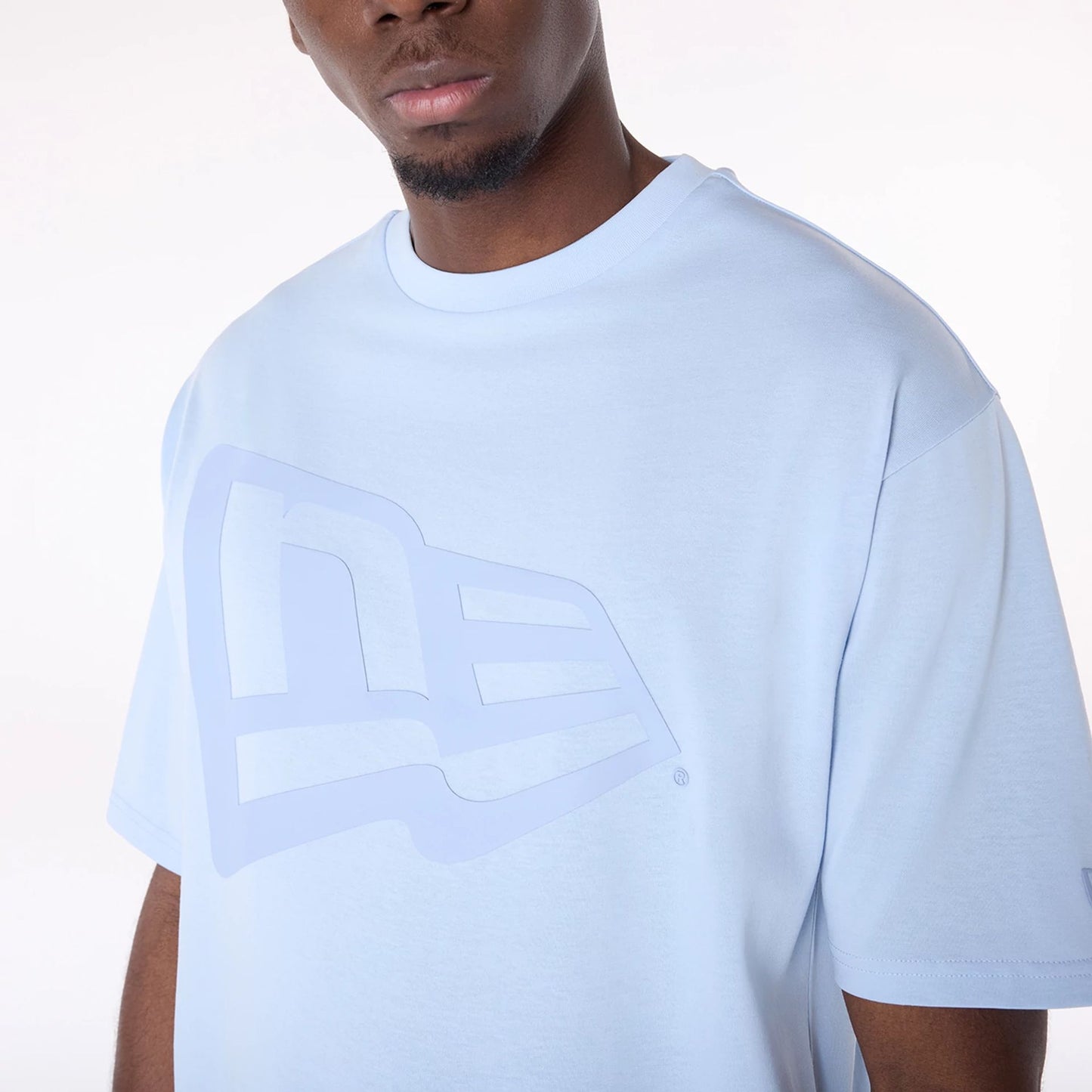 The Male model is wearing New Era Flag Pastel Blue Oversized T-Shirt 3