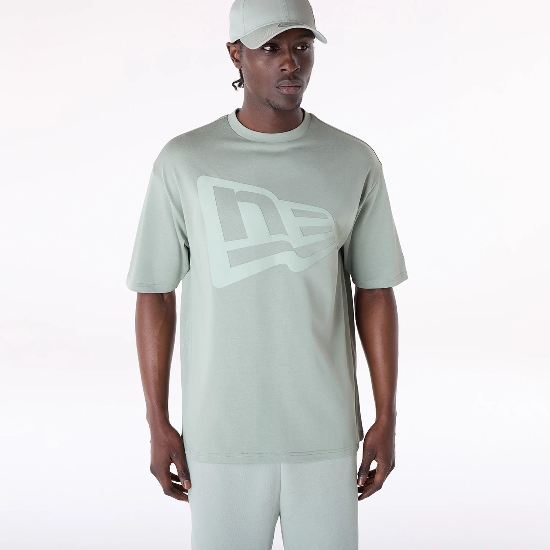 The Male model is wearing New Era Flag Pastel Green Oversized T-Shirt 1