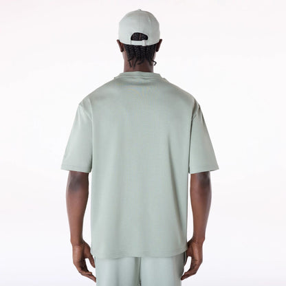 The Male model is wearing New Era Flag Pastel Green Oversized T-Shirt 2