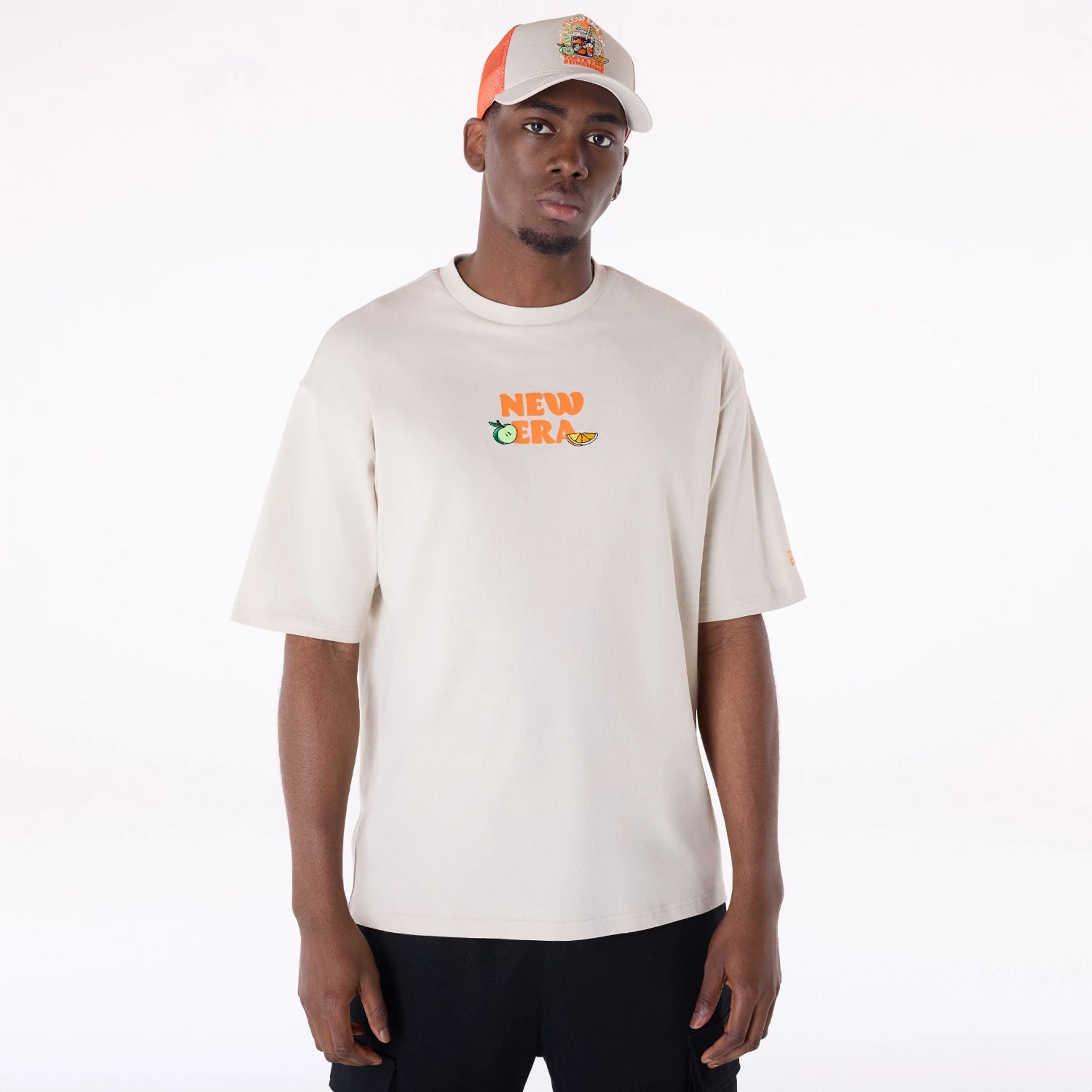 The Male model is wearing New Era Drink Graphic Cream Oversized T-Shirt 1