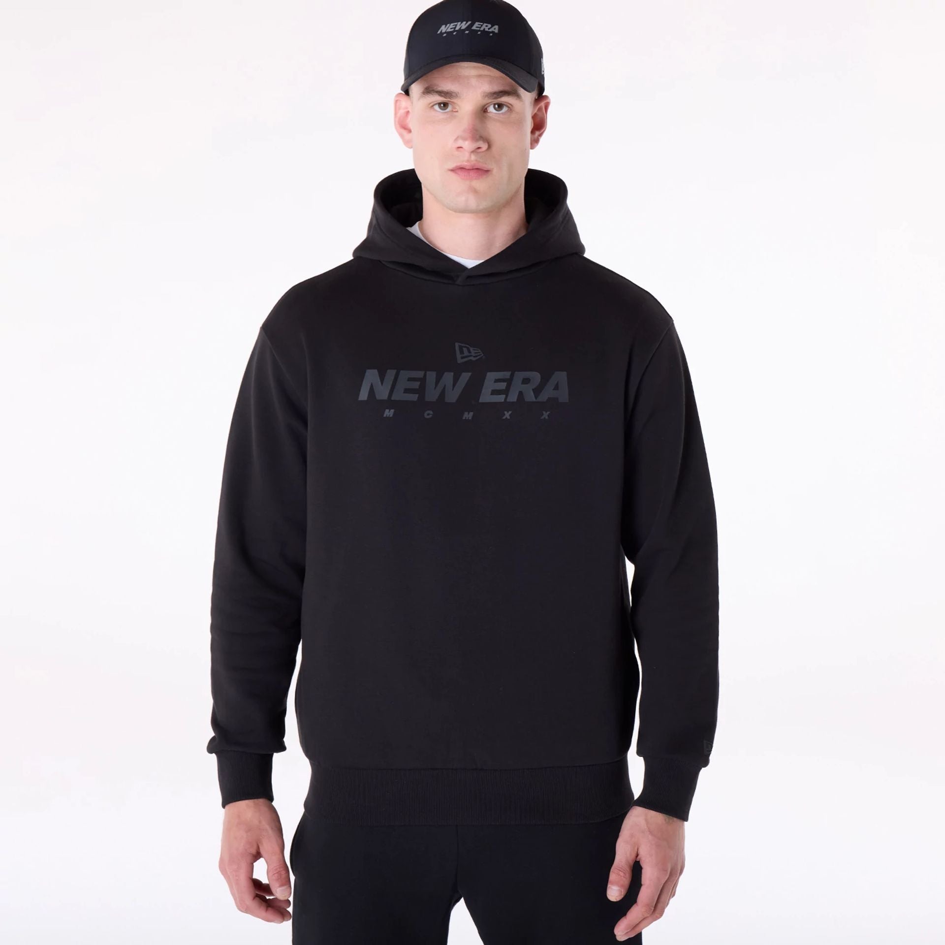 The Male model is wearing New Era Flag Black Oversized Pullover Hoodie 1