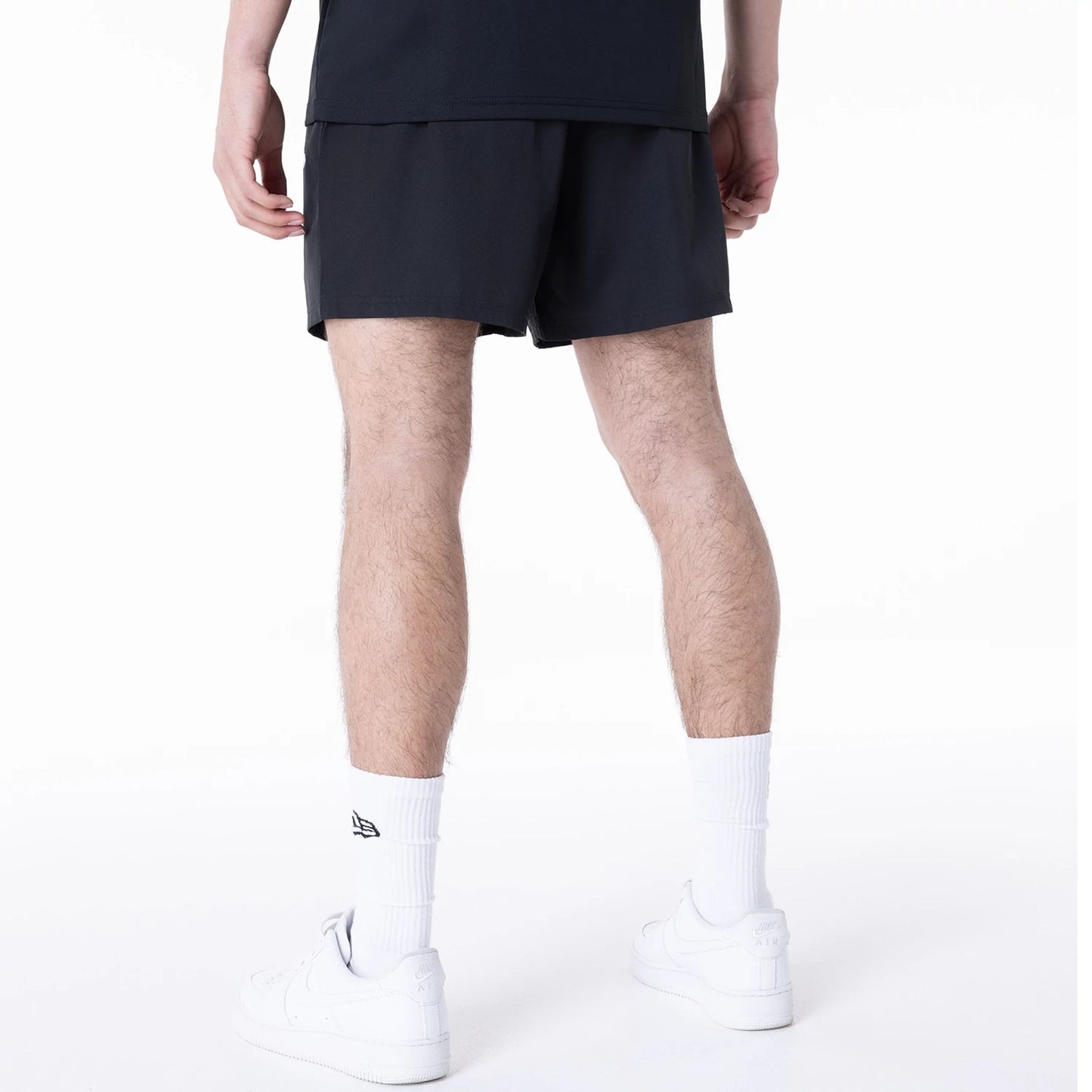 The Male model is wearing New York Yankees League Essential Black Shorts 6