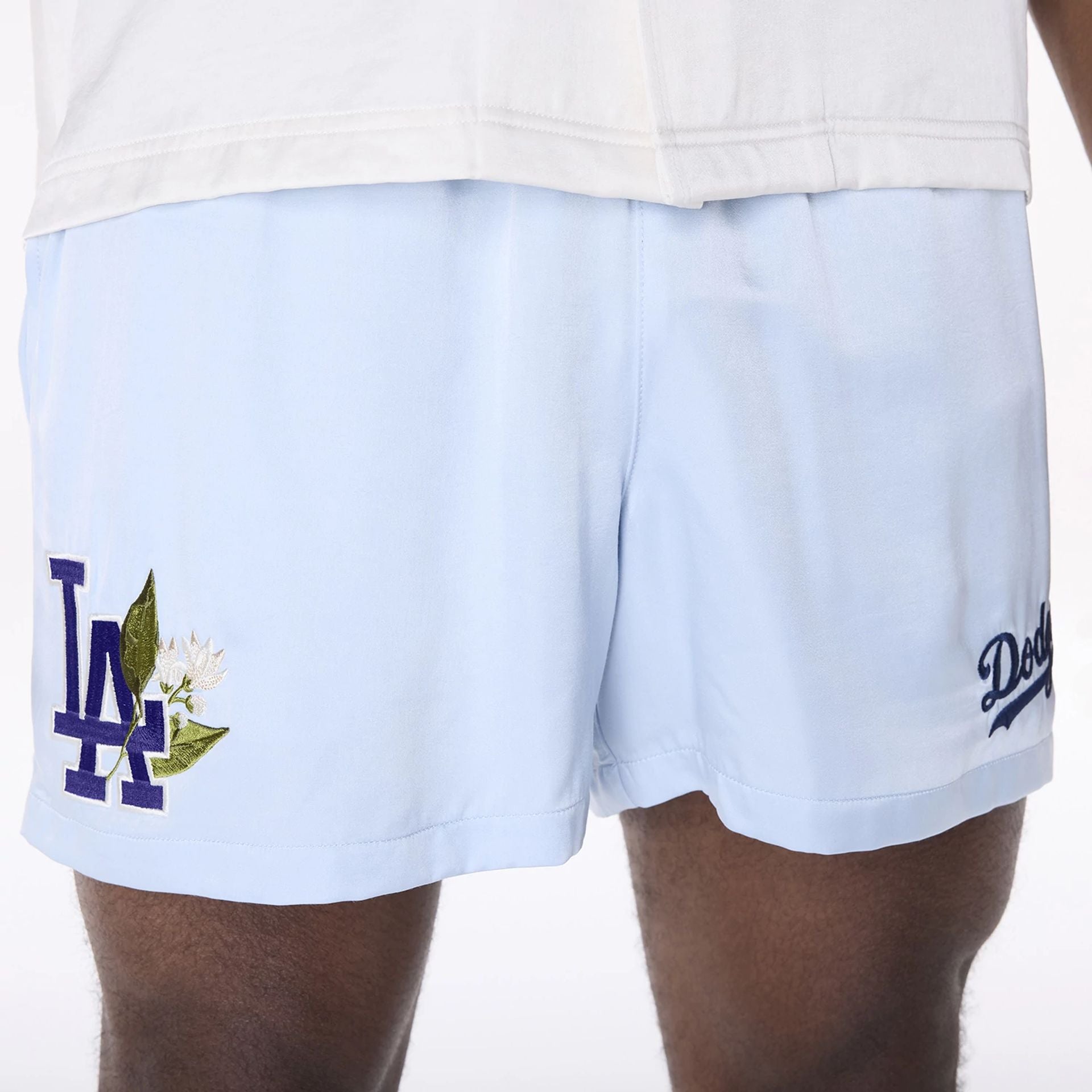 The Male model is wearing LA Dodgers MLB Woven Pastel Blue Shorts 7