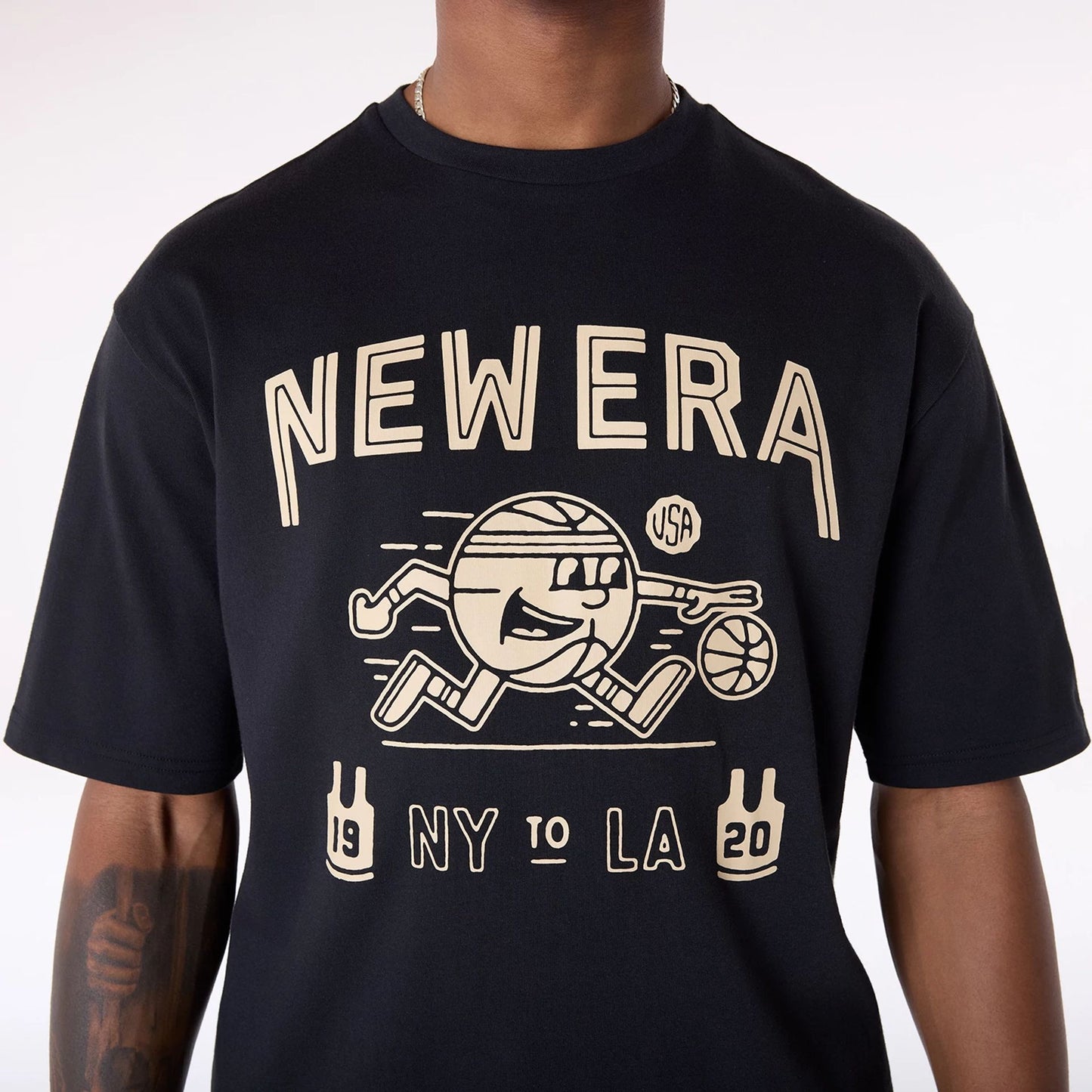 The Male model is wearing New Era Basketball Graphic Black T-Shirt 5