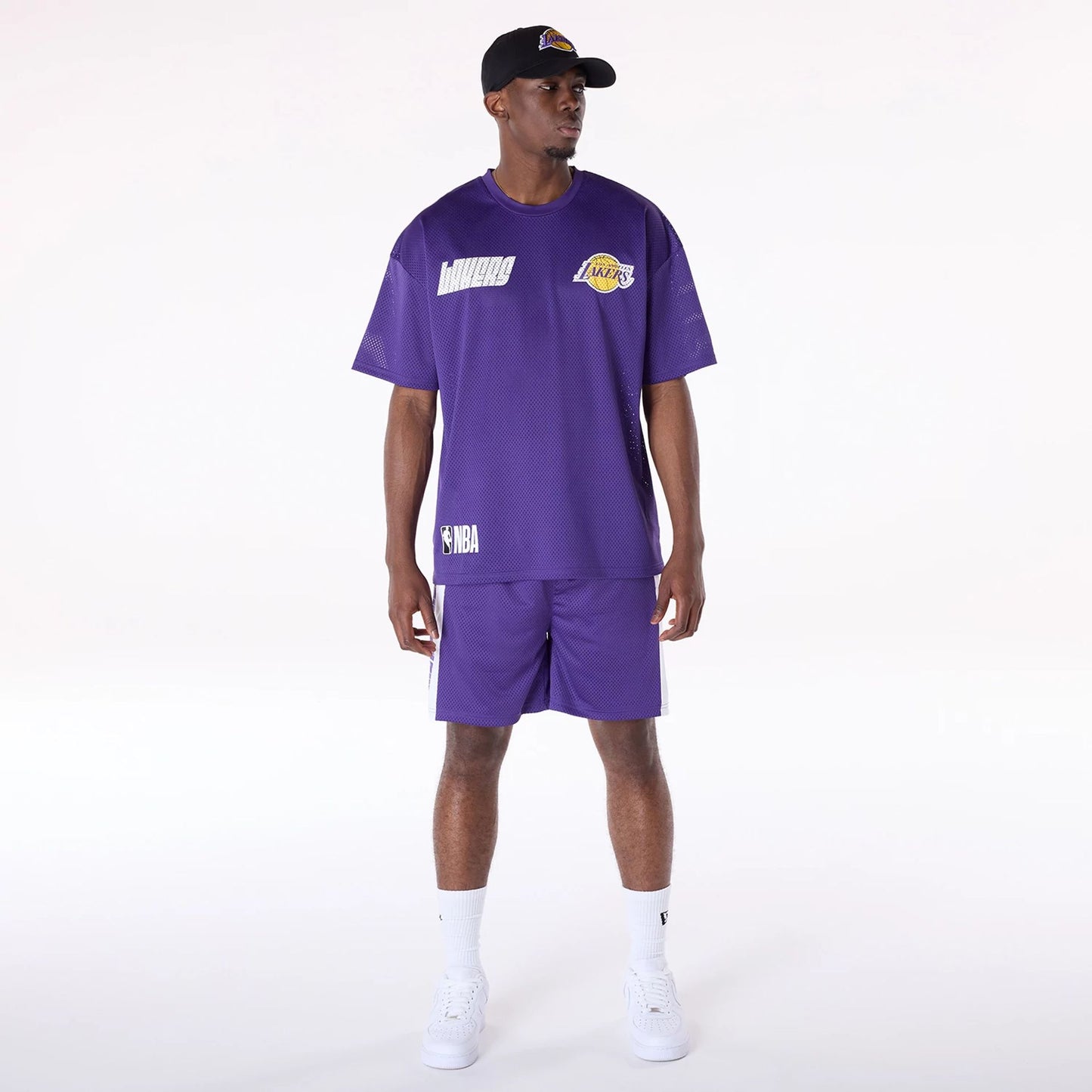 The Male model is wearing LA Lakers NBA Graphic Purple Mesh Shorts 8