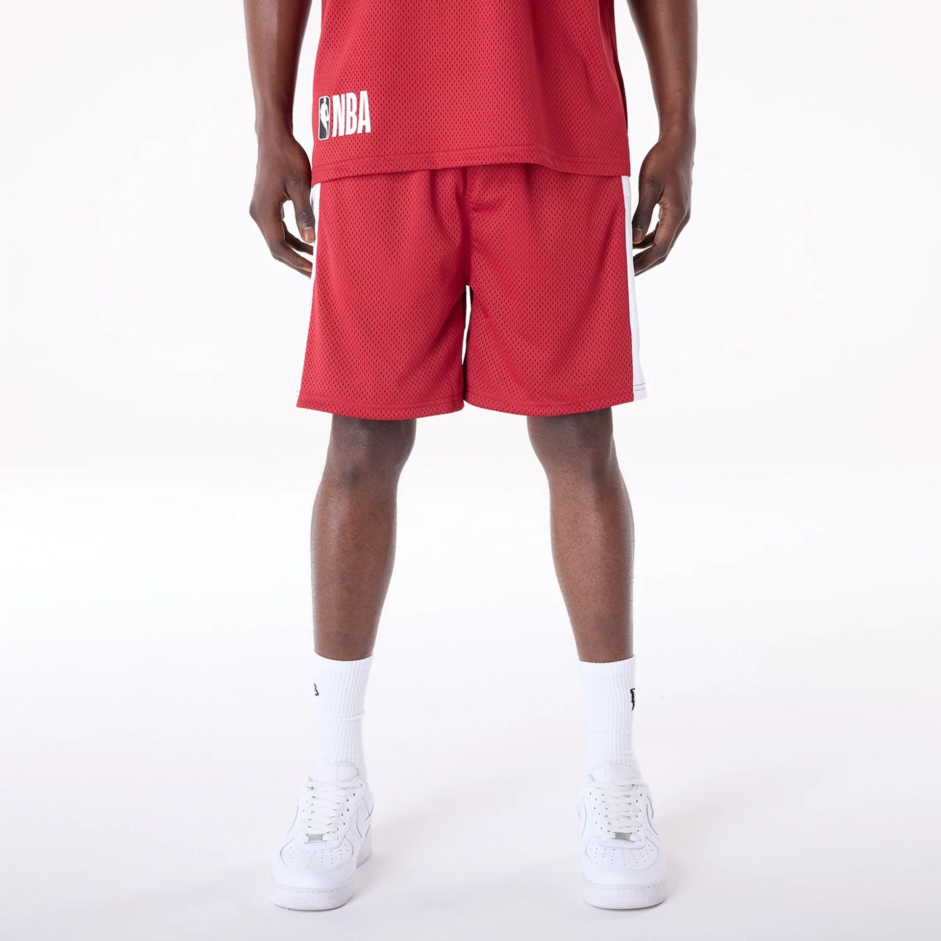 The Male model is wearing Miami Heat NBA Graphic Dark Red Mesh Shorts 1