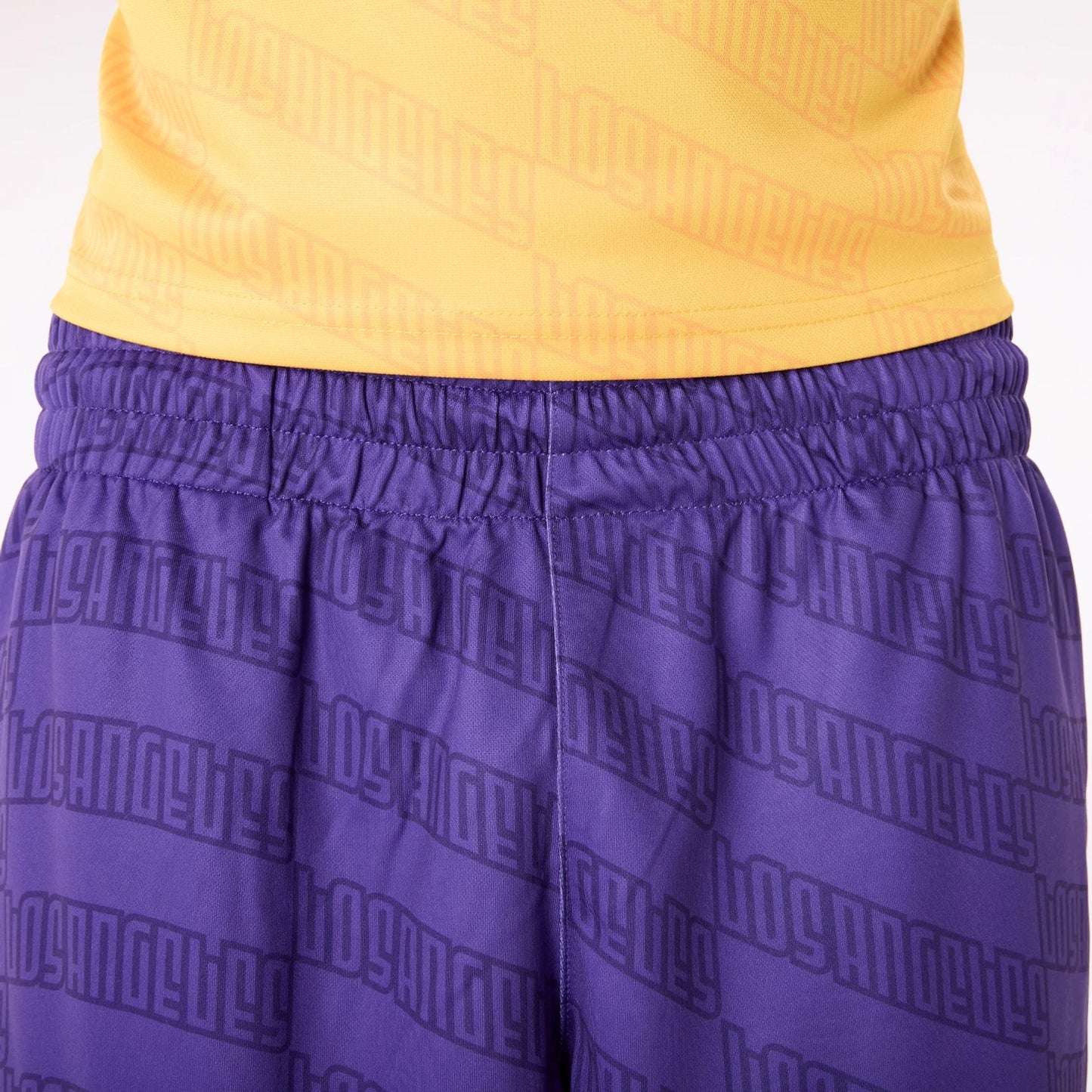 The Male model is wearing LA Lakers NBA All Over Print Graphic Purple Shorts 4