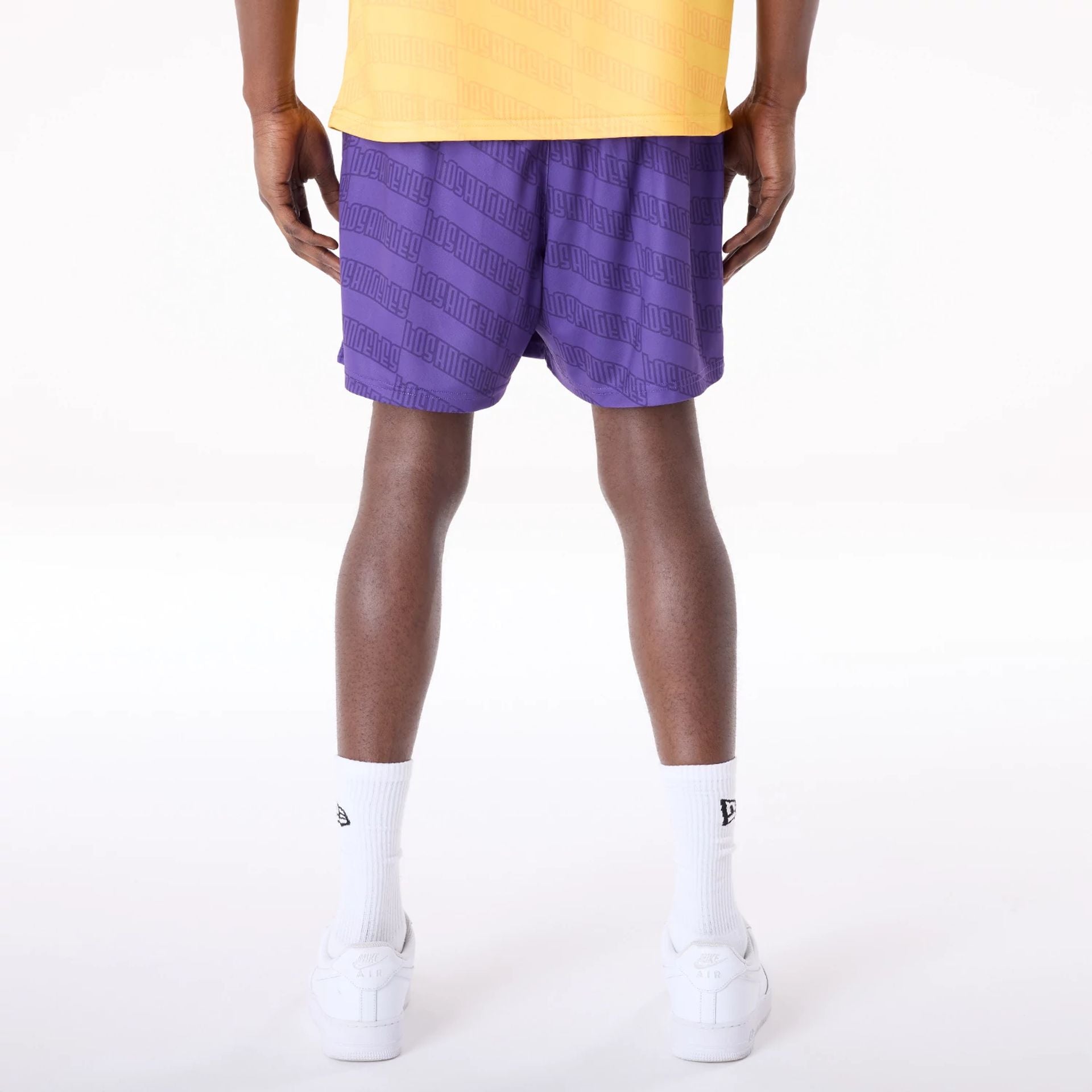 The Male model is wearing LA Lakers NBA All Over Print Graphic Purple Shorts 2