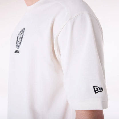 The Male model is wearing Brooklyn Nets NBA Wordmark Open White Oversized T-Shirt 5