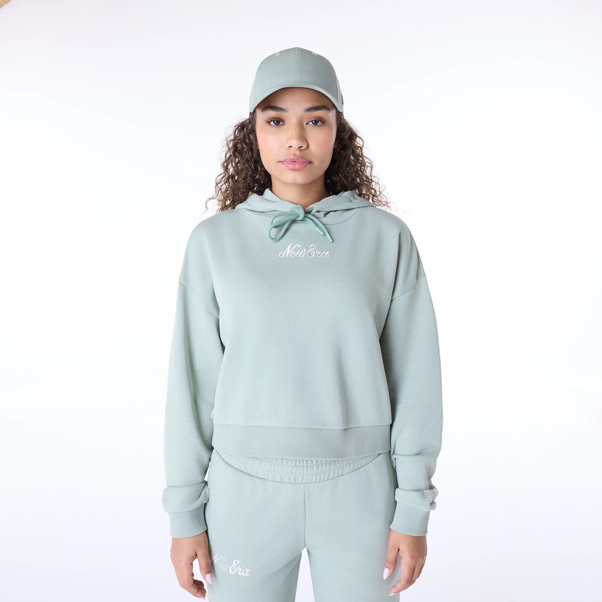 The Female model is wearing Womens New Era Script Pastel Green Pullover Hoodie 1