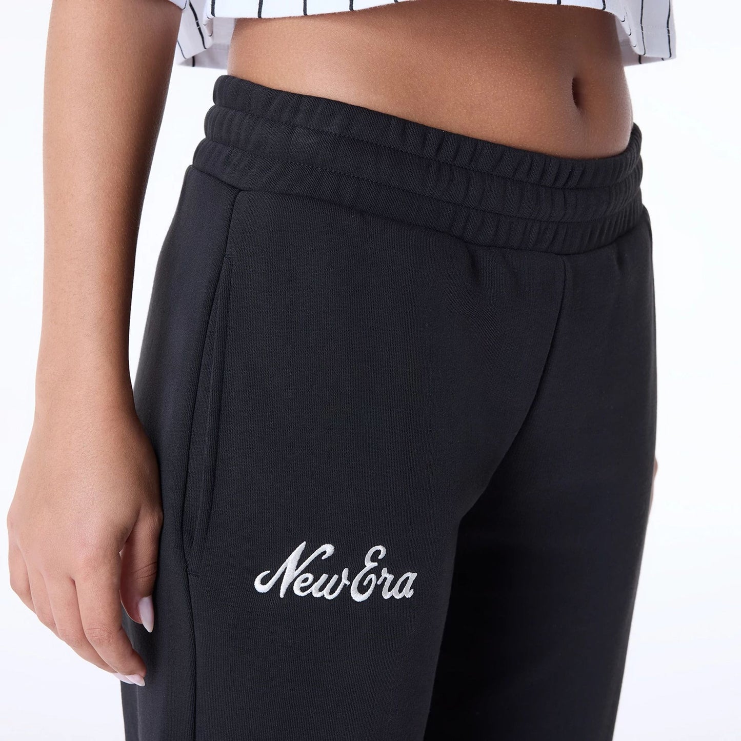 The Female model is wearing Womens New Era Script Black Joggers 3