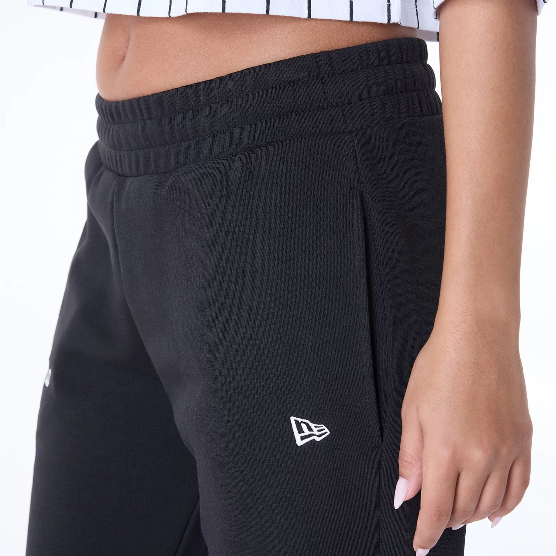 The Female model is wearing Womens New Era Script Black Joggers 4