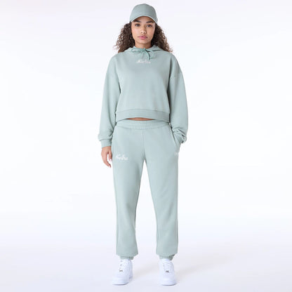 The Female model is wearing Womens New Era Script Pastel Green Joggers 8