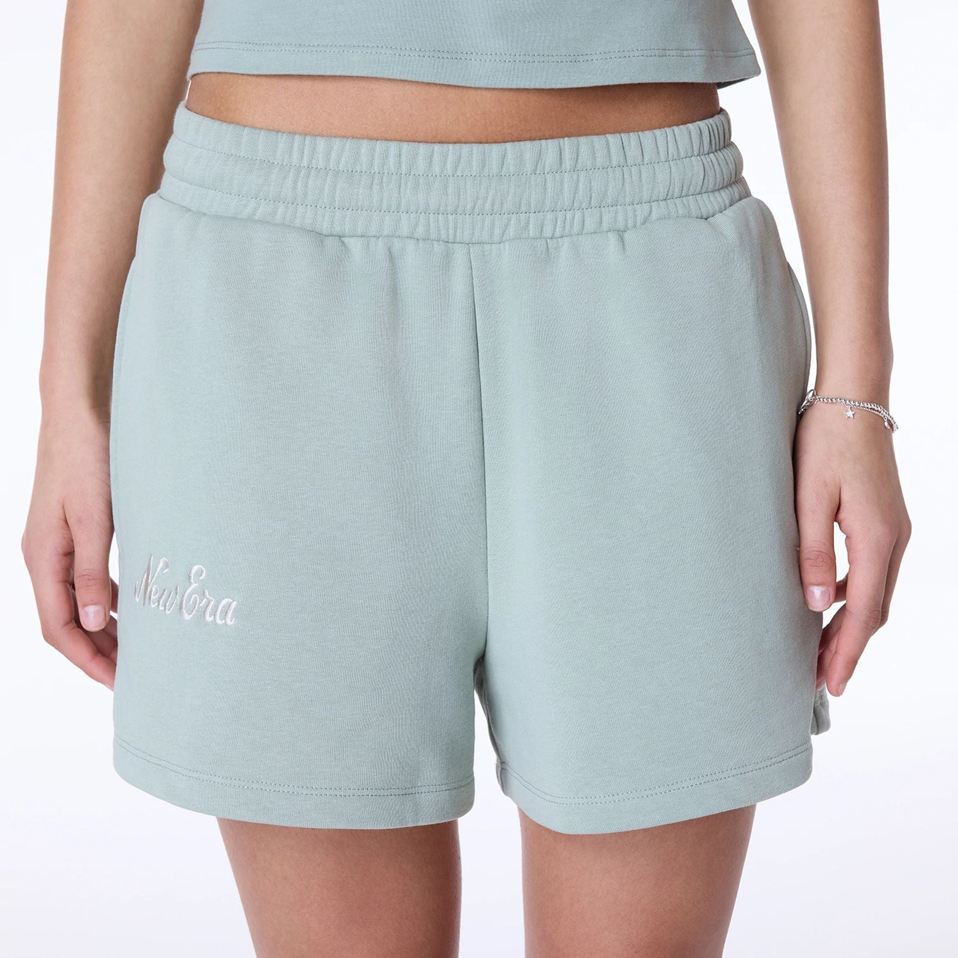 The Female model is wearing Womens New Era Script Pastel Green Shorts 2