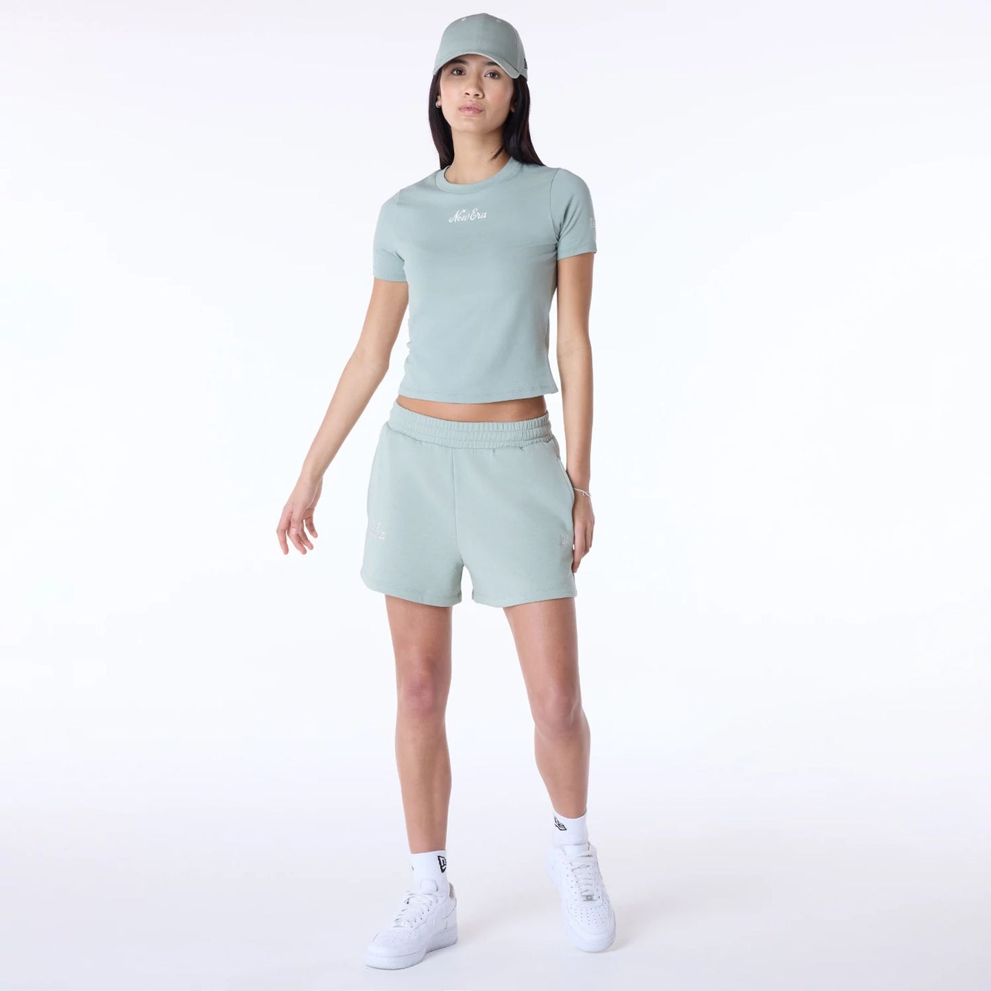 The Female model is wearing Womens New Era Script Pastel Green Shorts 8