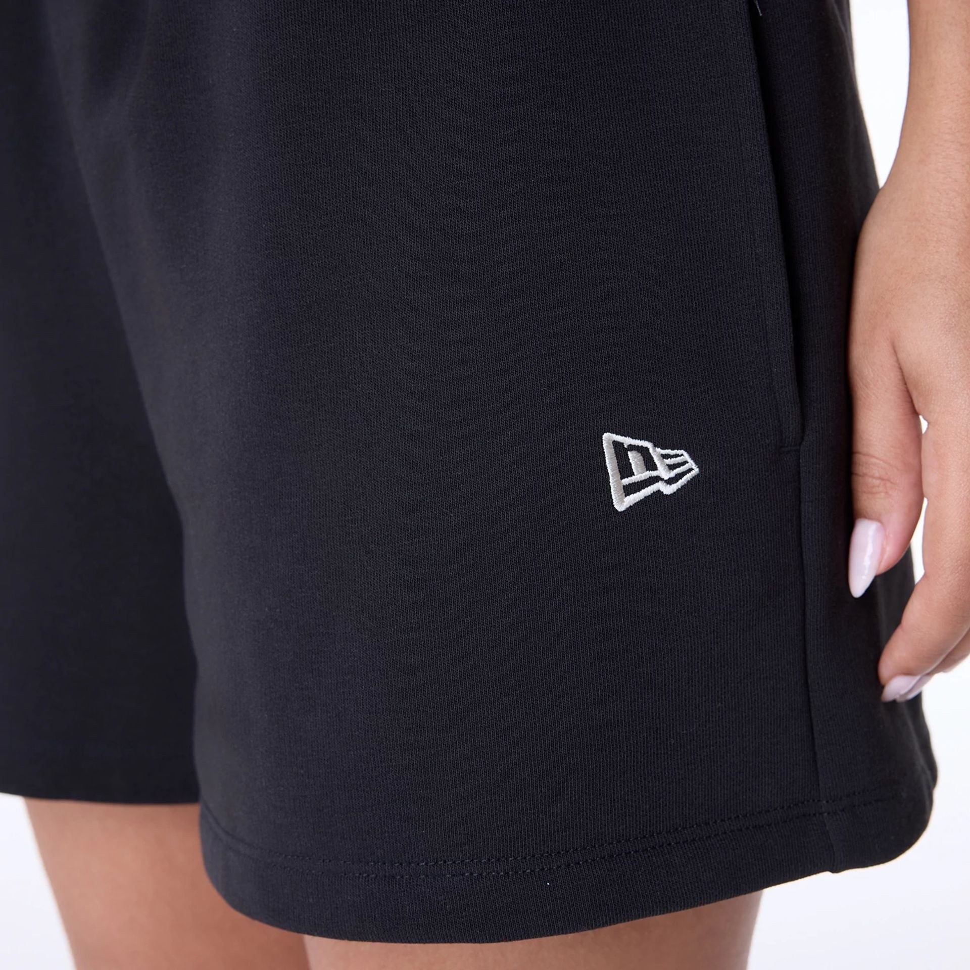 The Female model is wearing Womens New Era Script Black Shorts 4