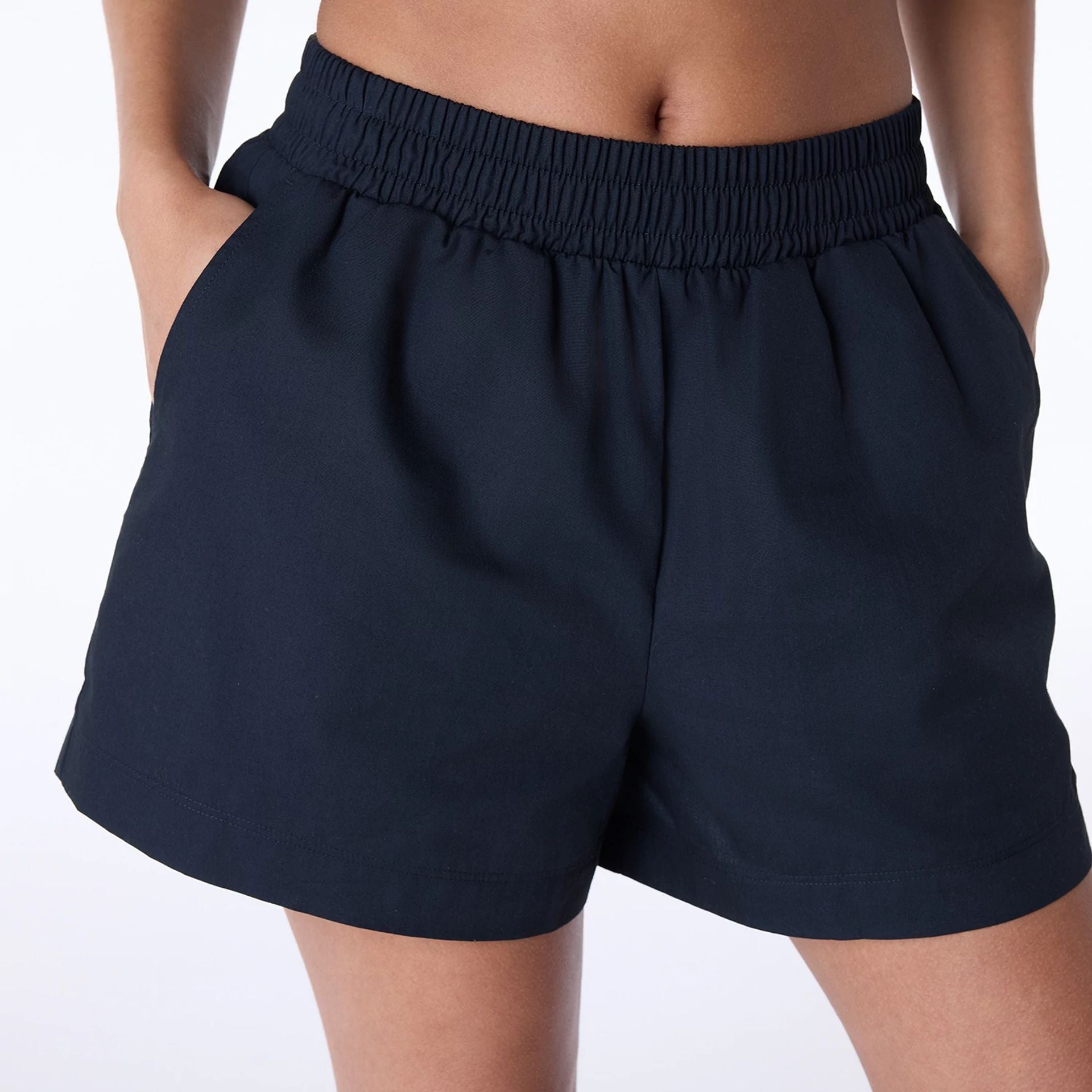 The Female model is wearing Womens New Era Cotton Black Shorts 2