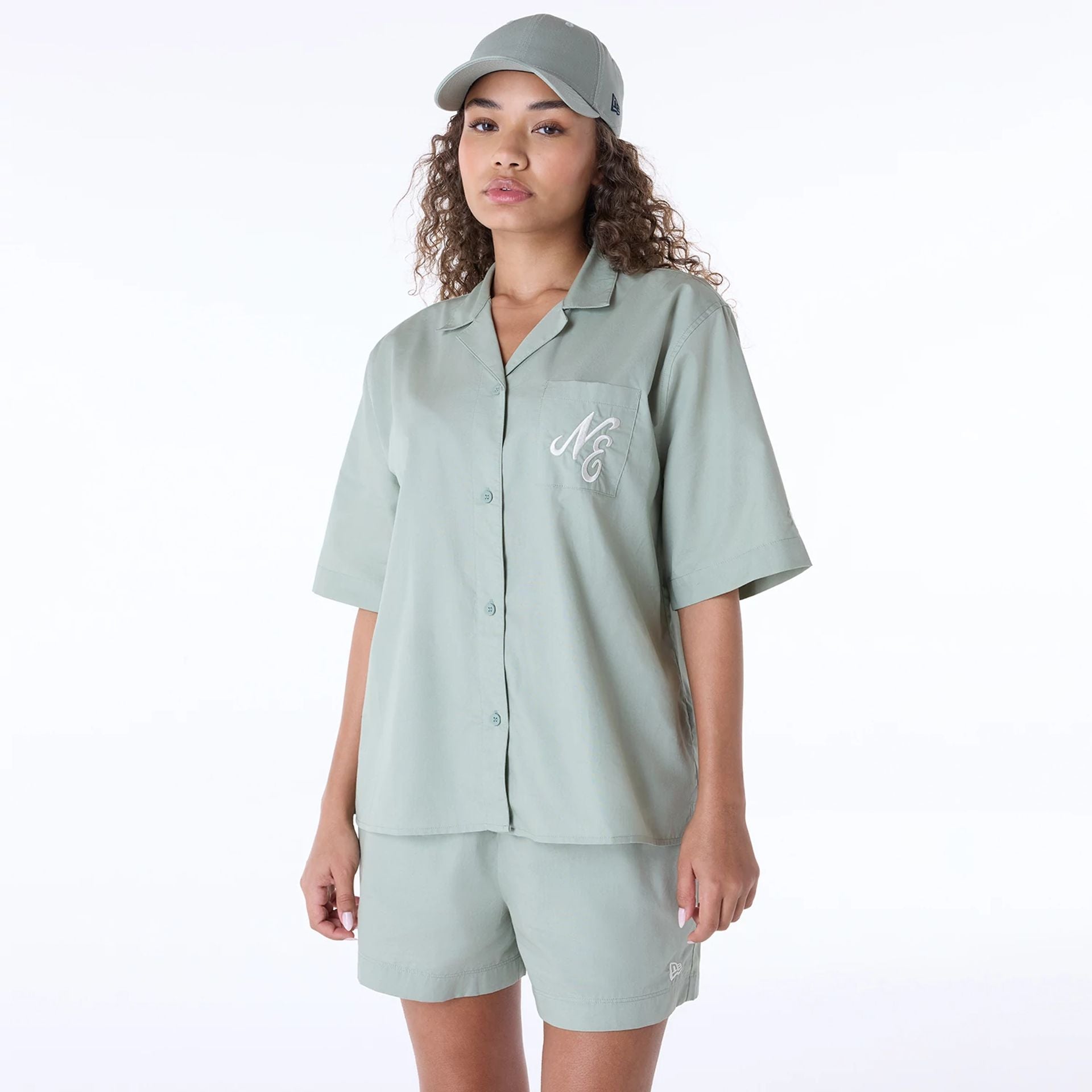 The Female model is wearing Womens New Era Revere Pastel Green T-Shirt 1