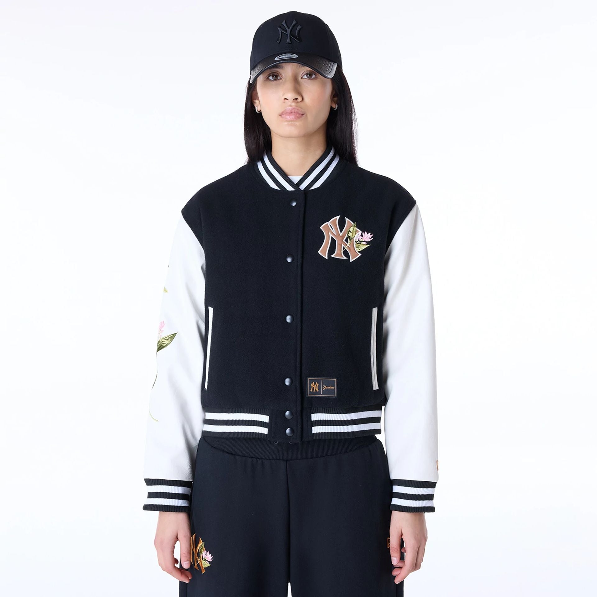 The Female model is wearing New York Yankees Womens MLB Floral Black Varsity Jacket 1