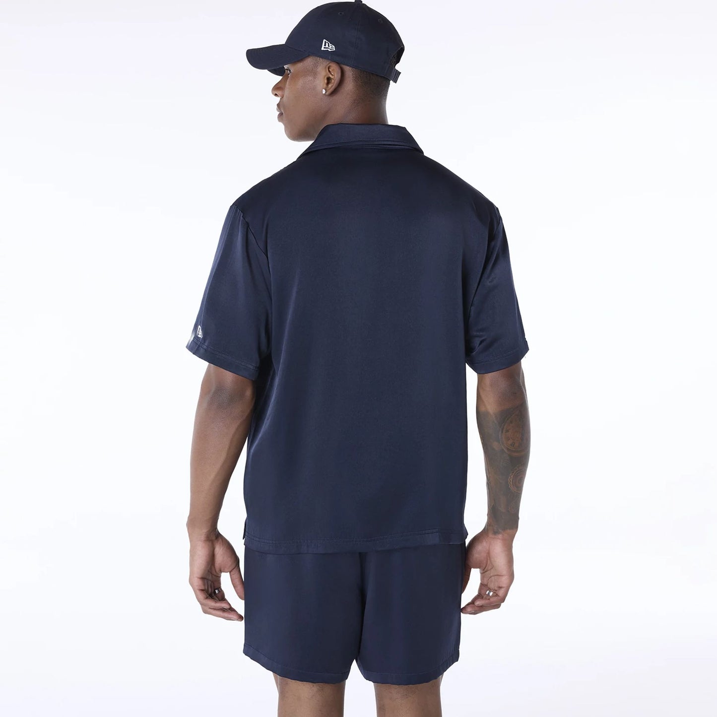 The Male model is wearing New Era Stripe Revere Navy Short Sleeve Shirt 2