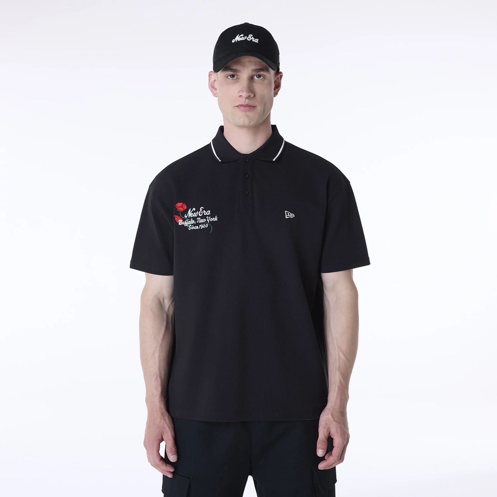 The Male model is wearing New Era Floral Polo Black T-Shirt 1