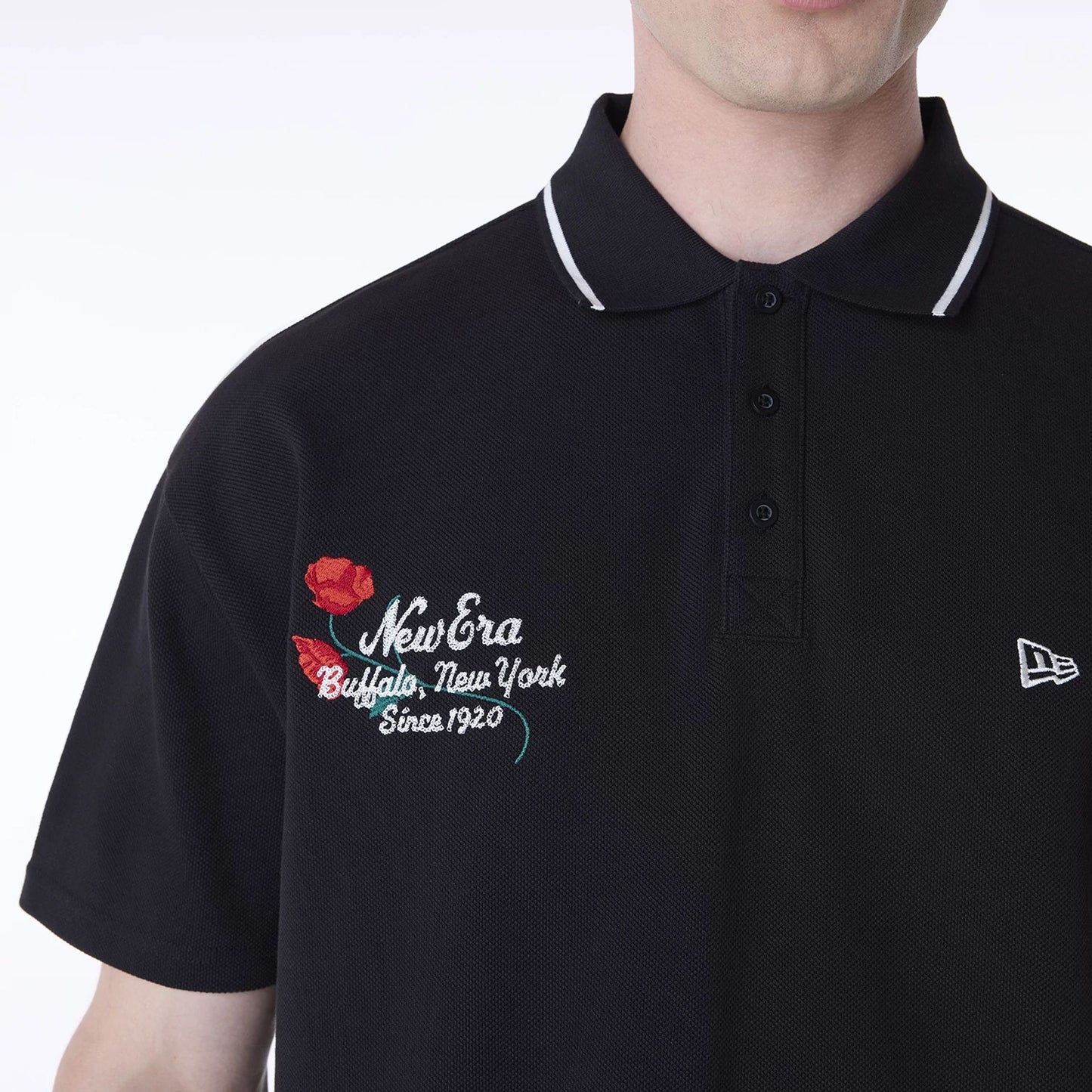 The Male model is wearing New Era Floral Polo Black T-Shirt 4