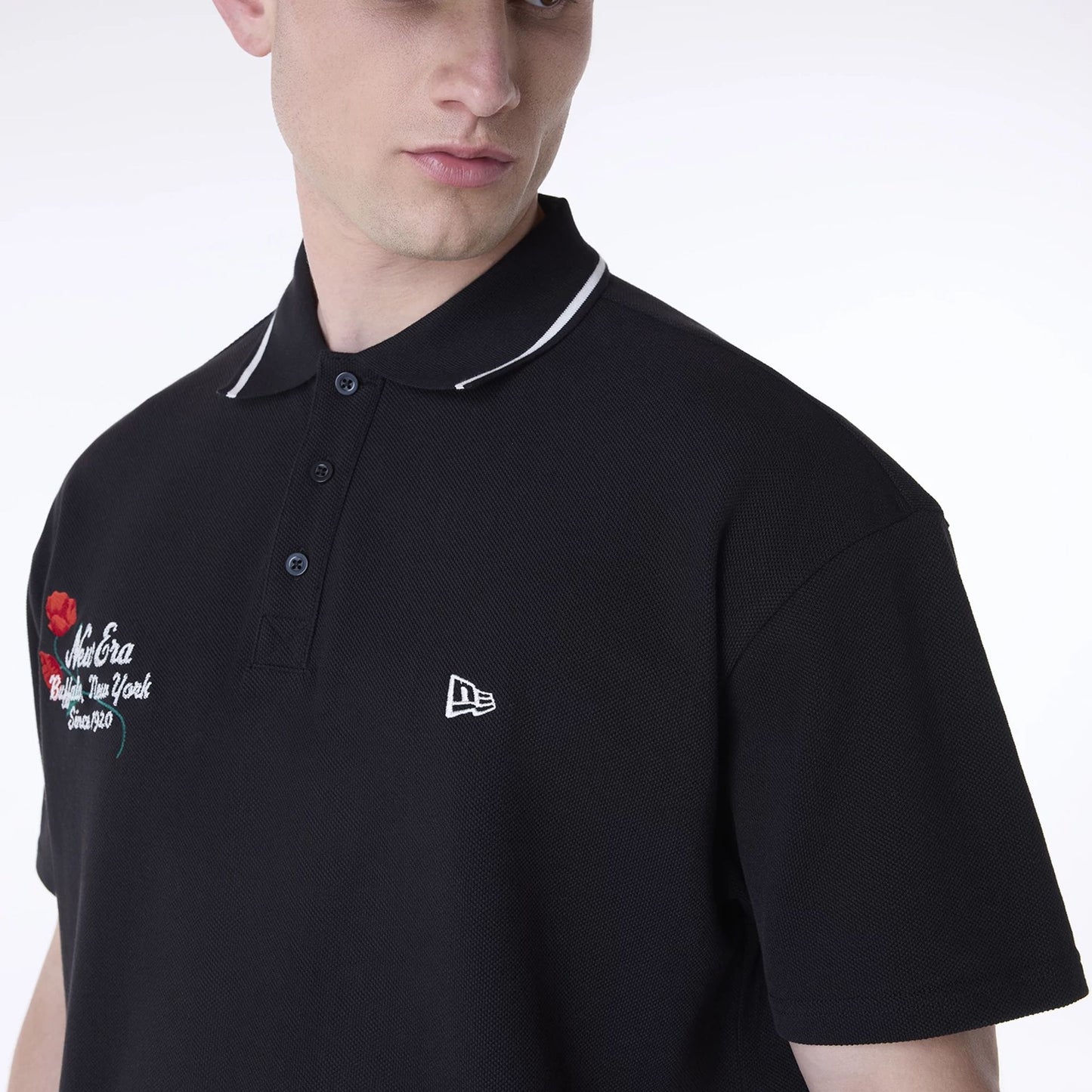 The Male model is wearing New Era Floral Polo Black T-Shirt 5