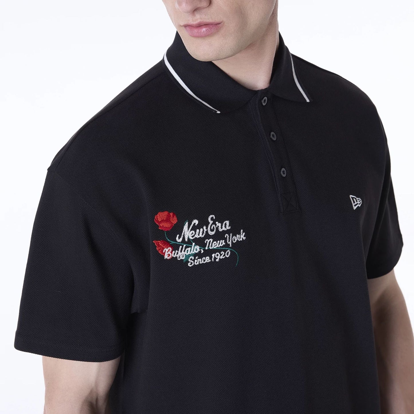 The Male model is wearing New Era Floral Polo Black T-Shirt 6