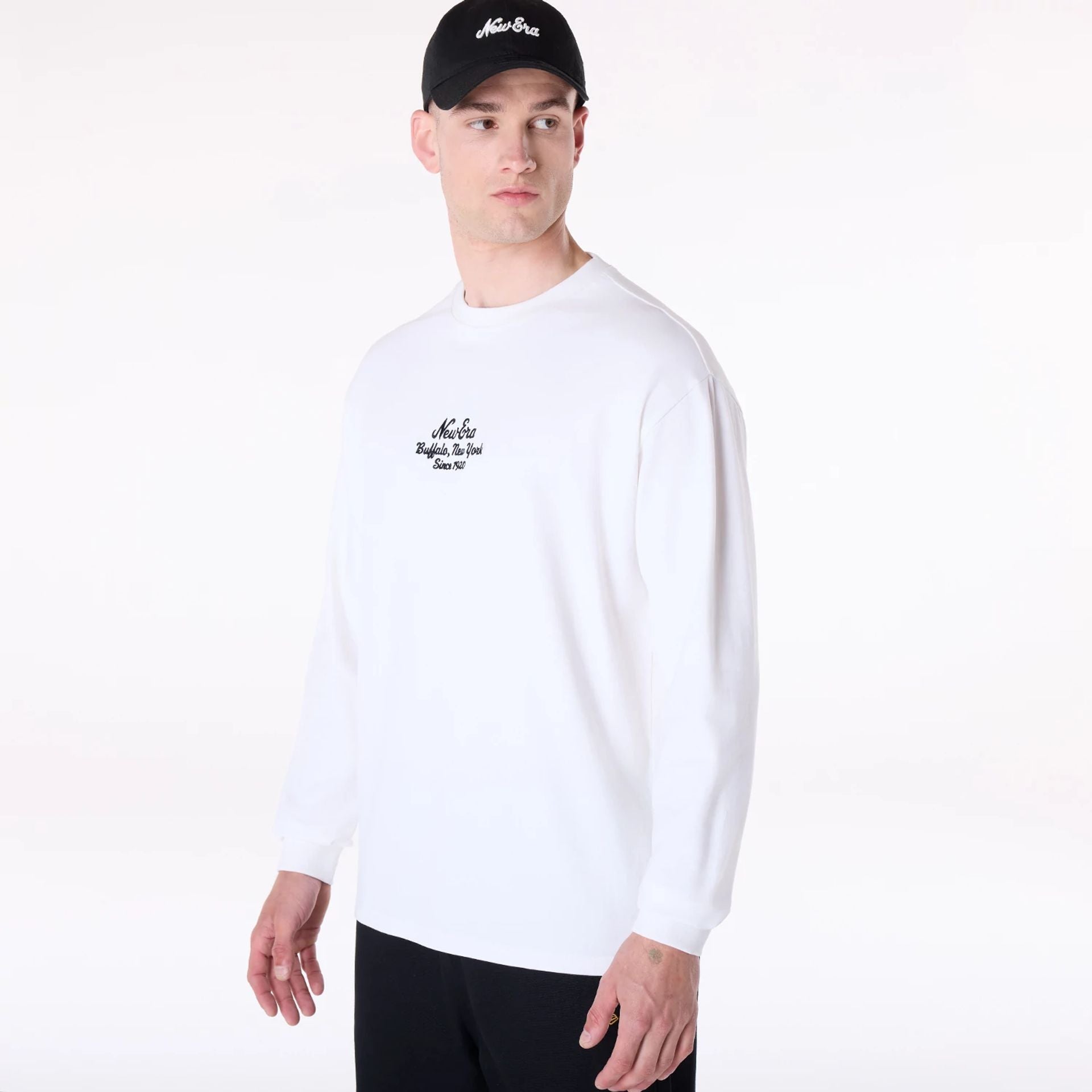 The Male model is wearing New Era Graphic White Long Sleeve T-Shirt 5