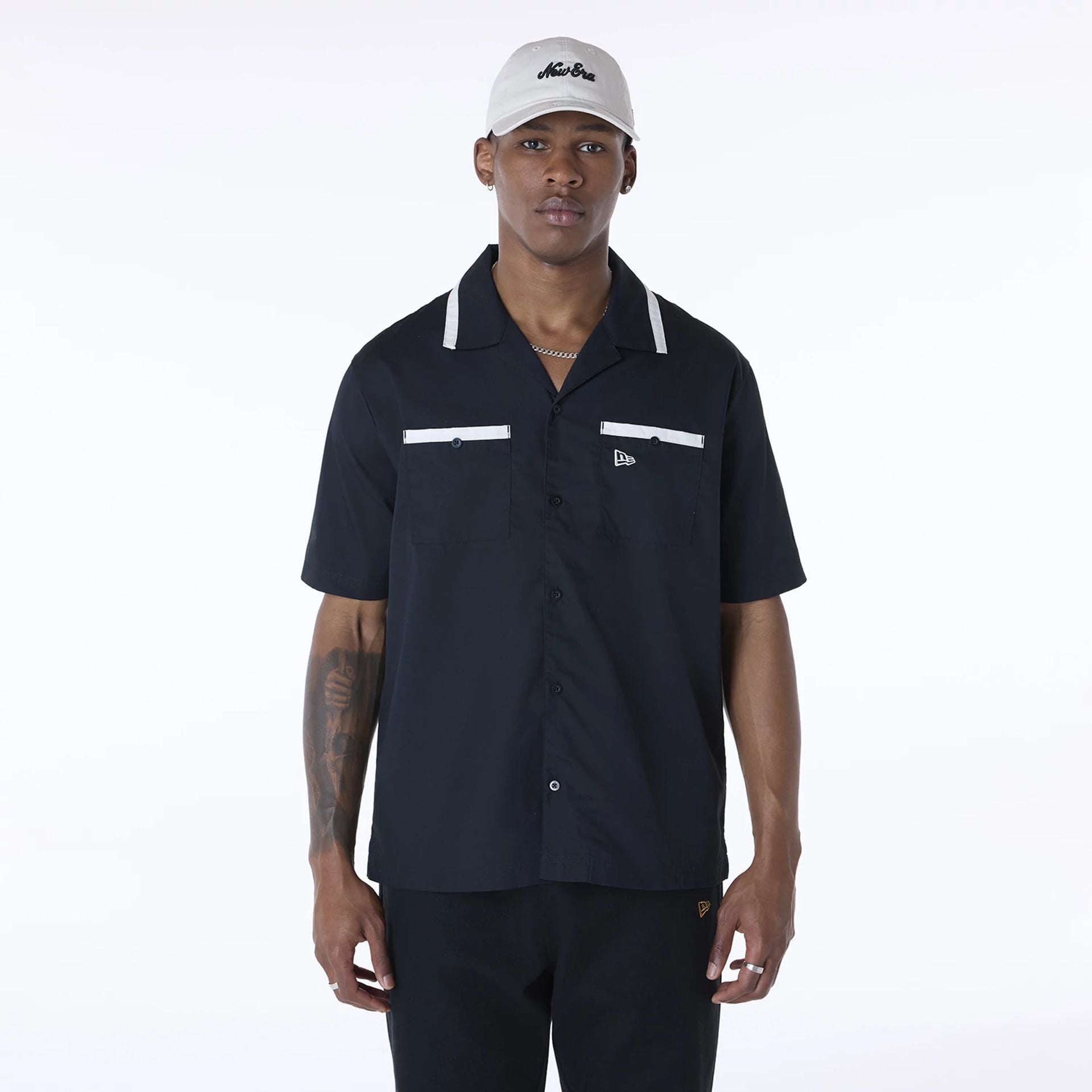 The Male model is wearing New Era Revere Black Short Sleeve Shirt 1