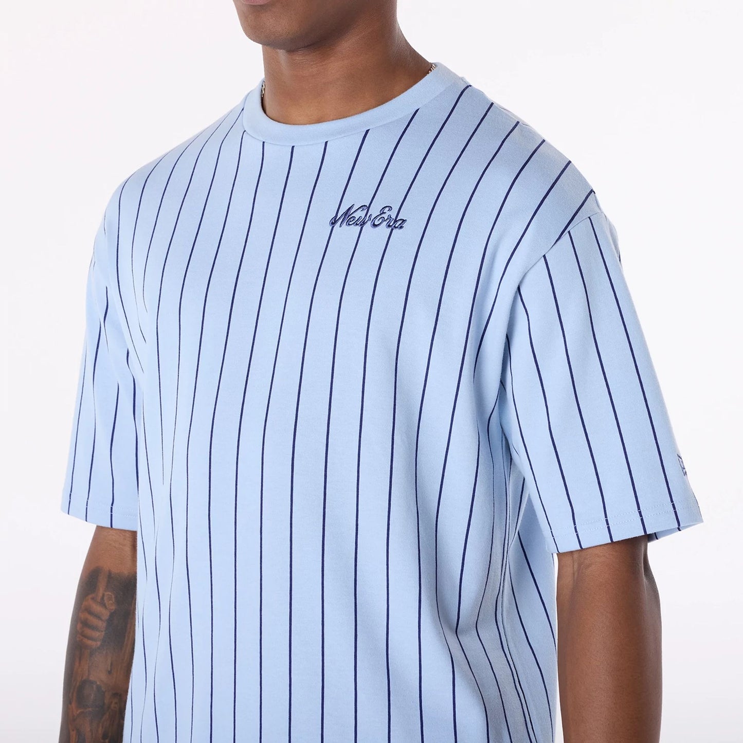 The Male model is wearing New Era Pinstripe Pastel Blue Oversized T-Shirt 5