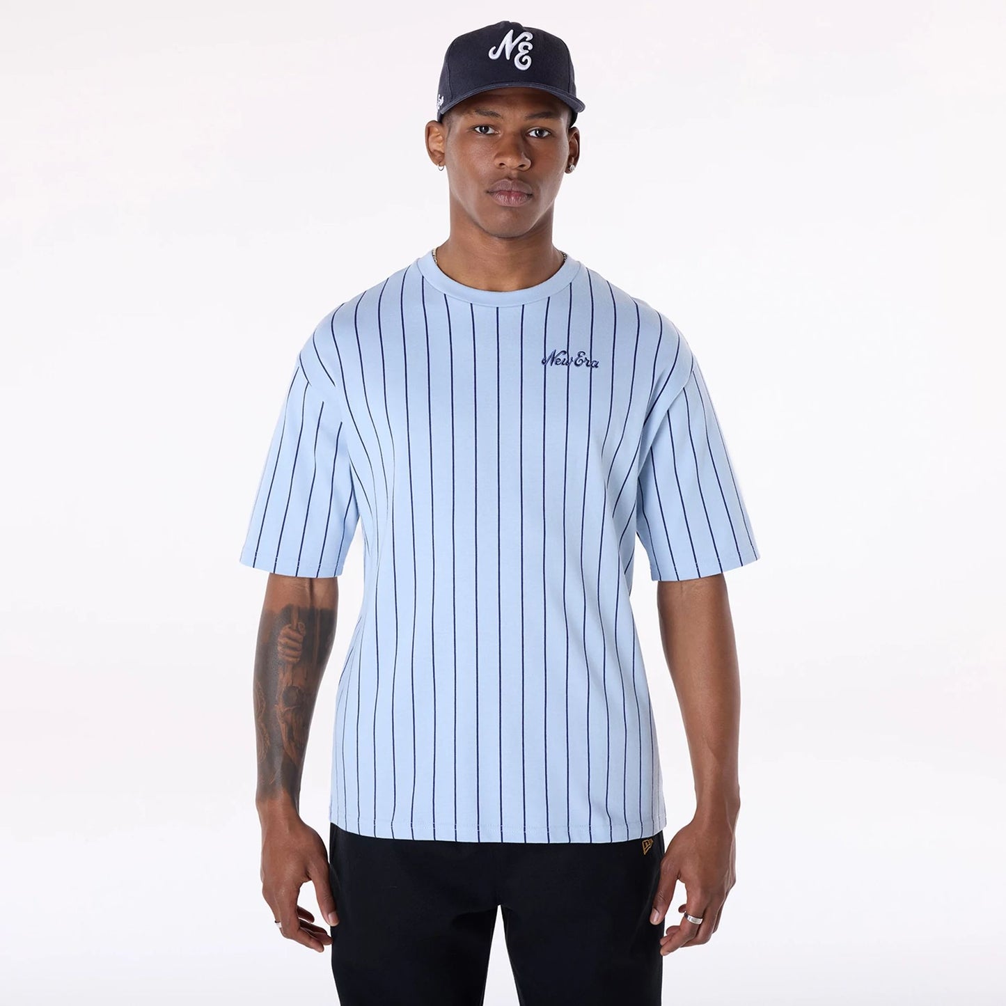 The Male model is wearing New Era Pinstripe Pastel Blue Oversized T-Shirt 1