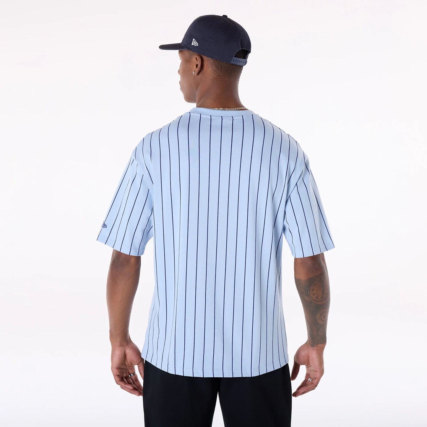 The Male model is wearing New Era Pinstripe Pastel Blue Oversized T-Shirt 2