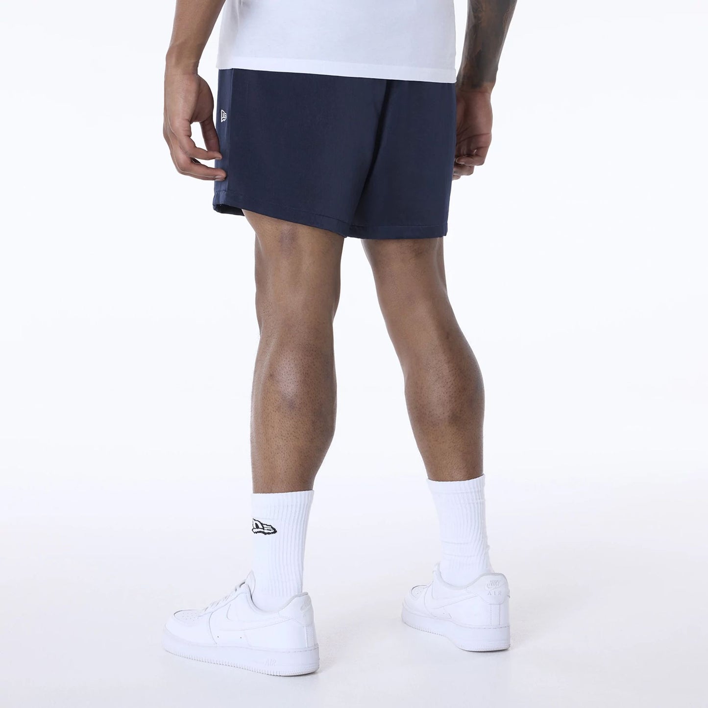 The Male model is wearing New Era Woven Navy Shorts 2