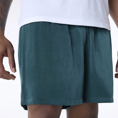 The Male model is wearing New Era Woven Dark Green Shorts 6