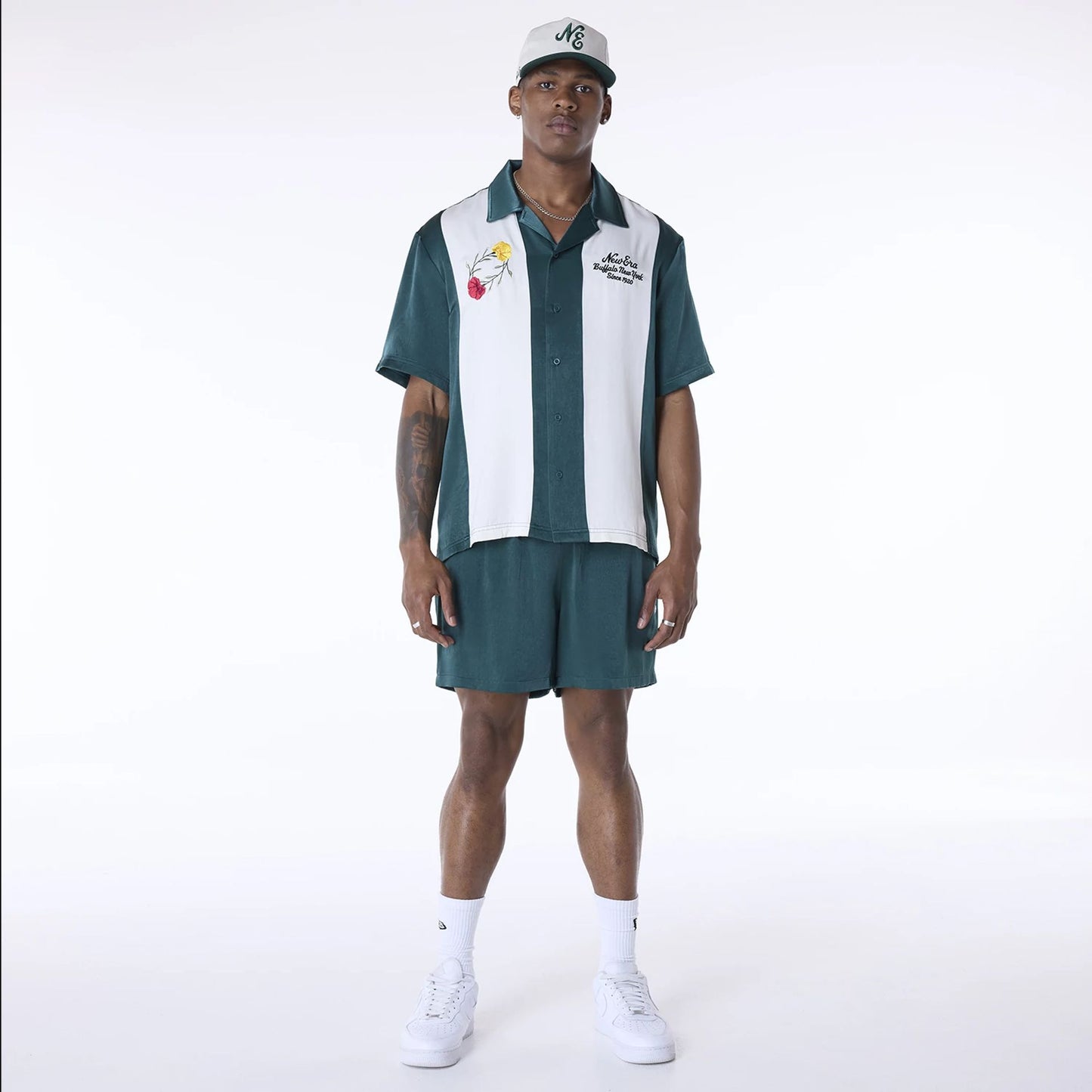 The Male model is wearing New Era Woven Dark Green Shorts 4