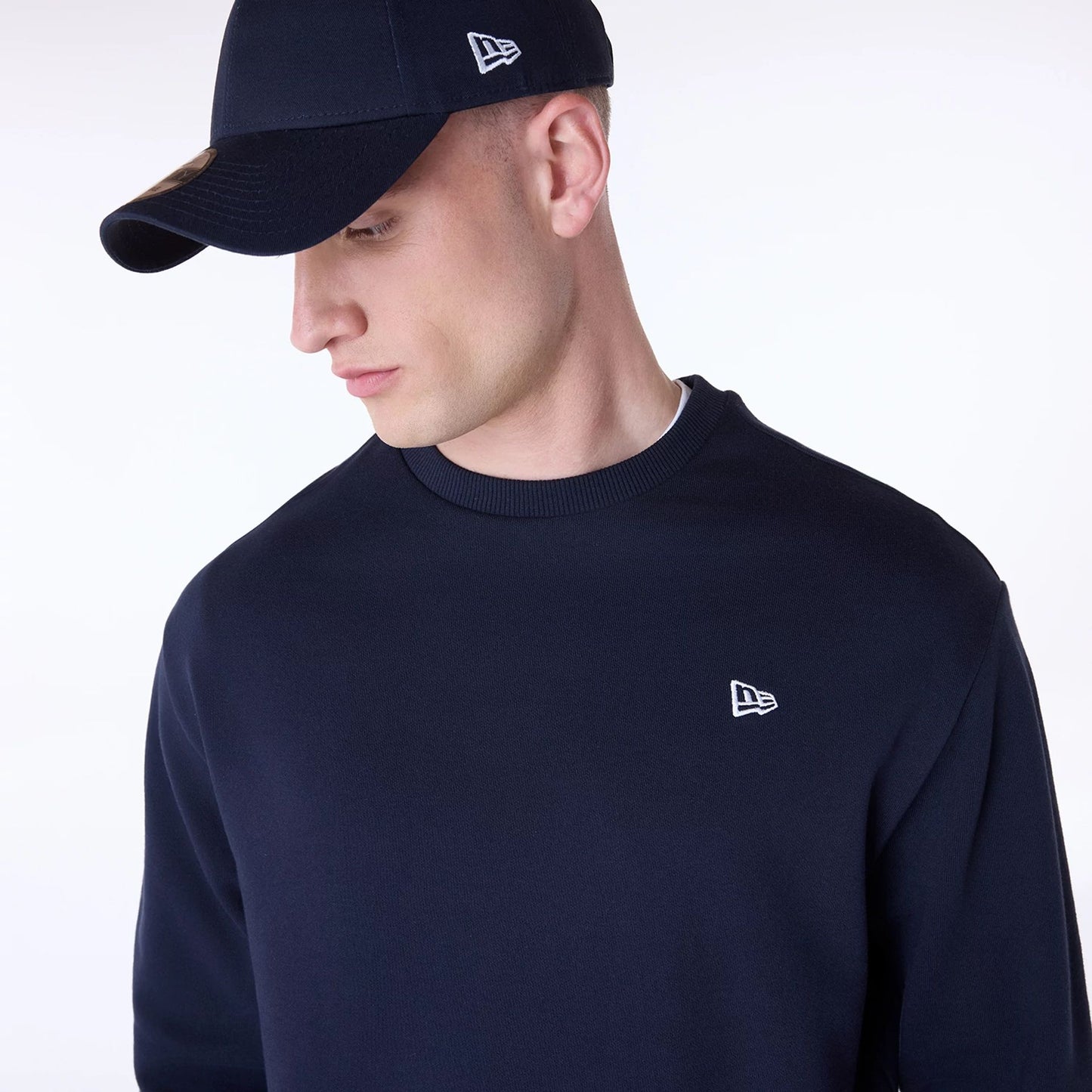 The Male model is wearing New Era Essential Navy Crew Neck Sweater 8