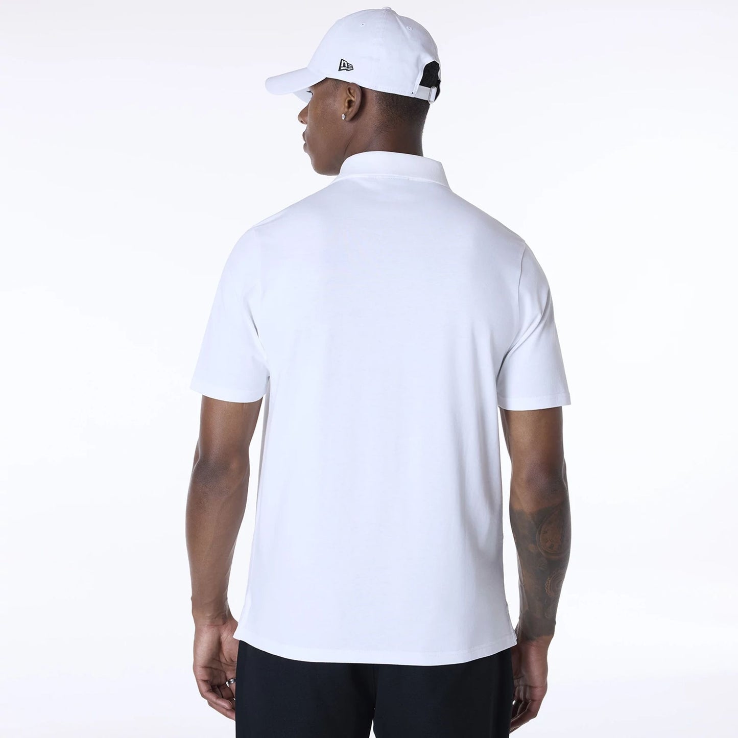 The Male model is wearing New Era Polo White T-Shirt 2