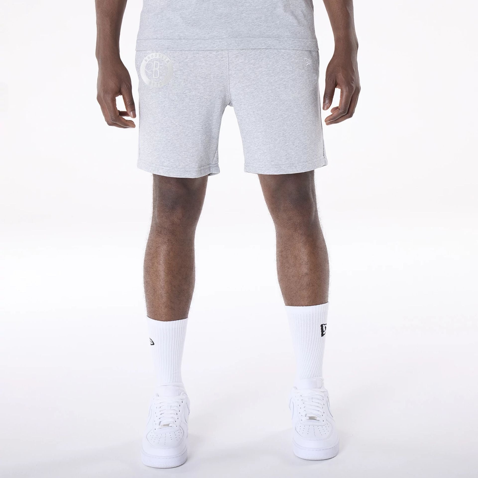 The Male model is wearing Brooklyn Nets NBA League Essential Grey Shorts 1