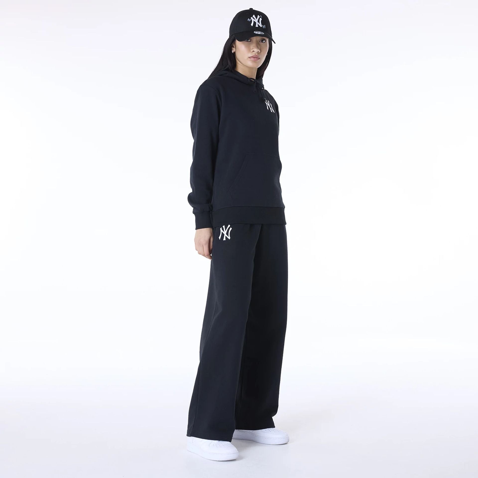 The Female model is wearing New York Yankees MLB League Essential Black Track Suit 7