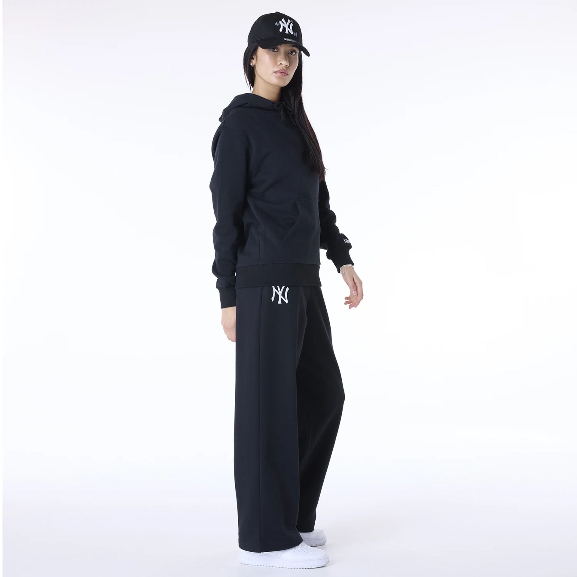 The Female model is wearing New York Yankees MLB League Essential Black Track Suit 8