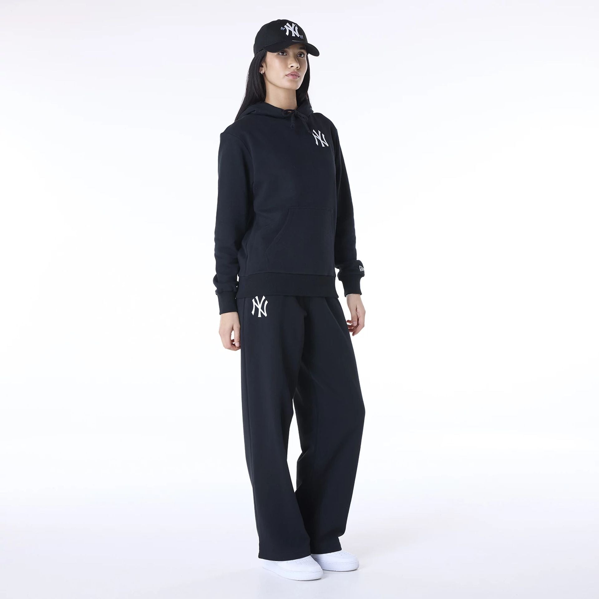 The Female model is wearing New York Yankees MLB League Essential Black Track Suit 1