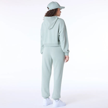 The Female model is wearing New Era Script Pastel Green Track Suit 5