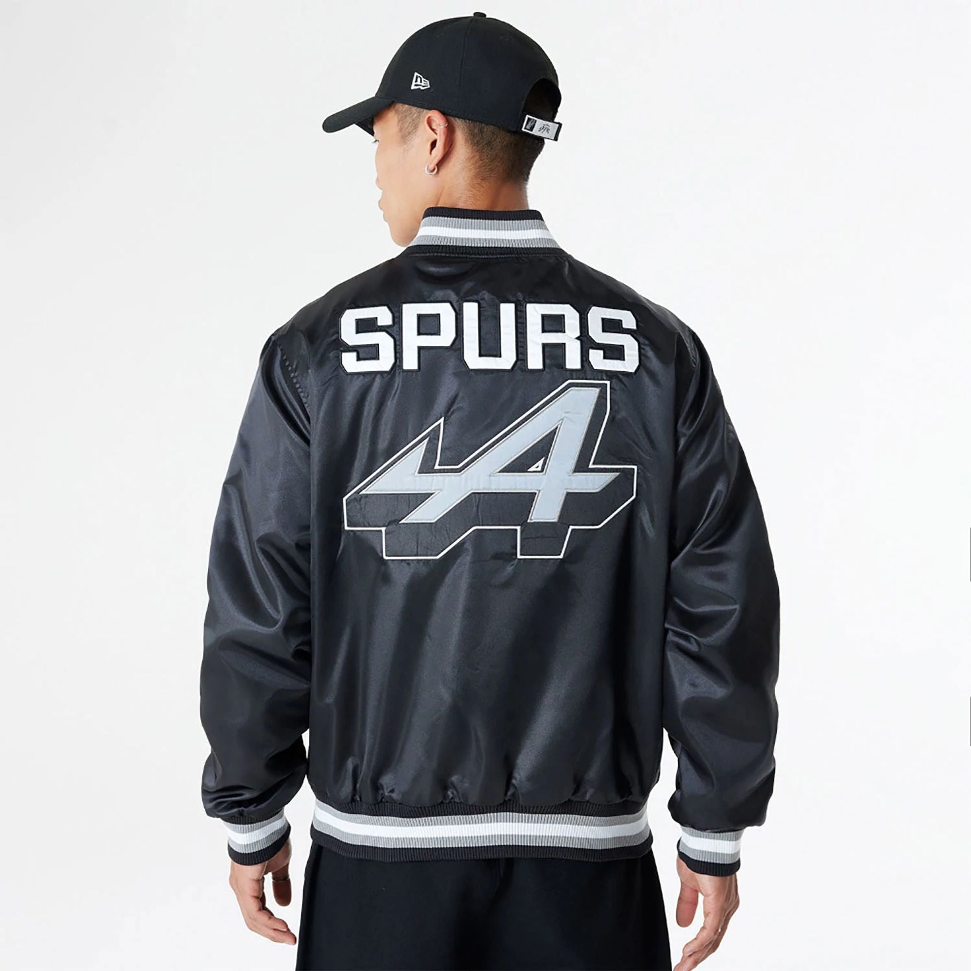 The Male model is wearing BTW Alpine F1 Racing x San Antonio Spurs Black Satin Bomber Jacket 2