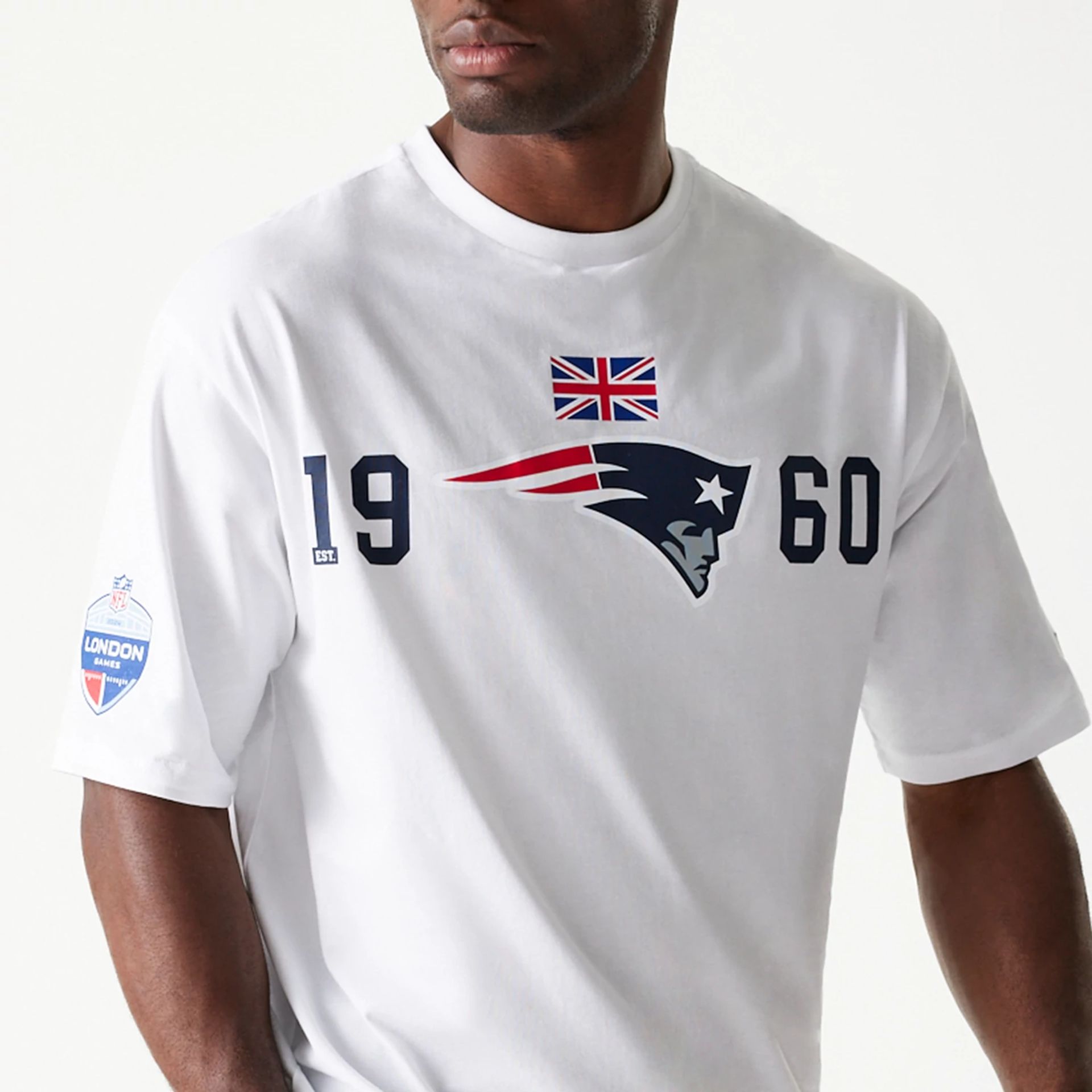 The Male model is wearing New England Patriots NFL Games Square Arch White Oversized T-Shirt 2