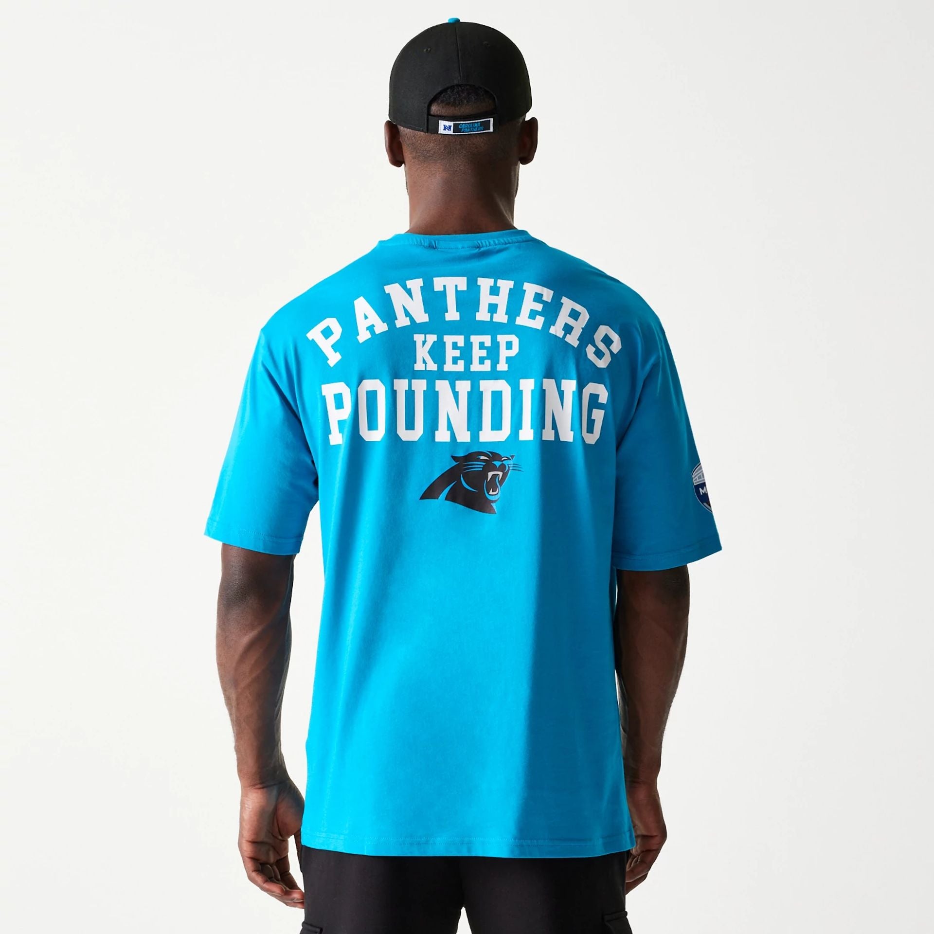 The Male model is wearing Carolina Panthers NFL Games Square Arch Bright Blue Oversized T-Shirt 7