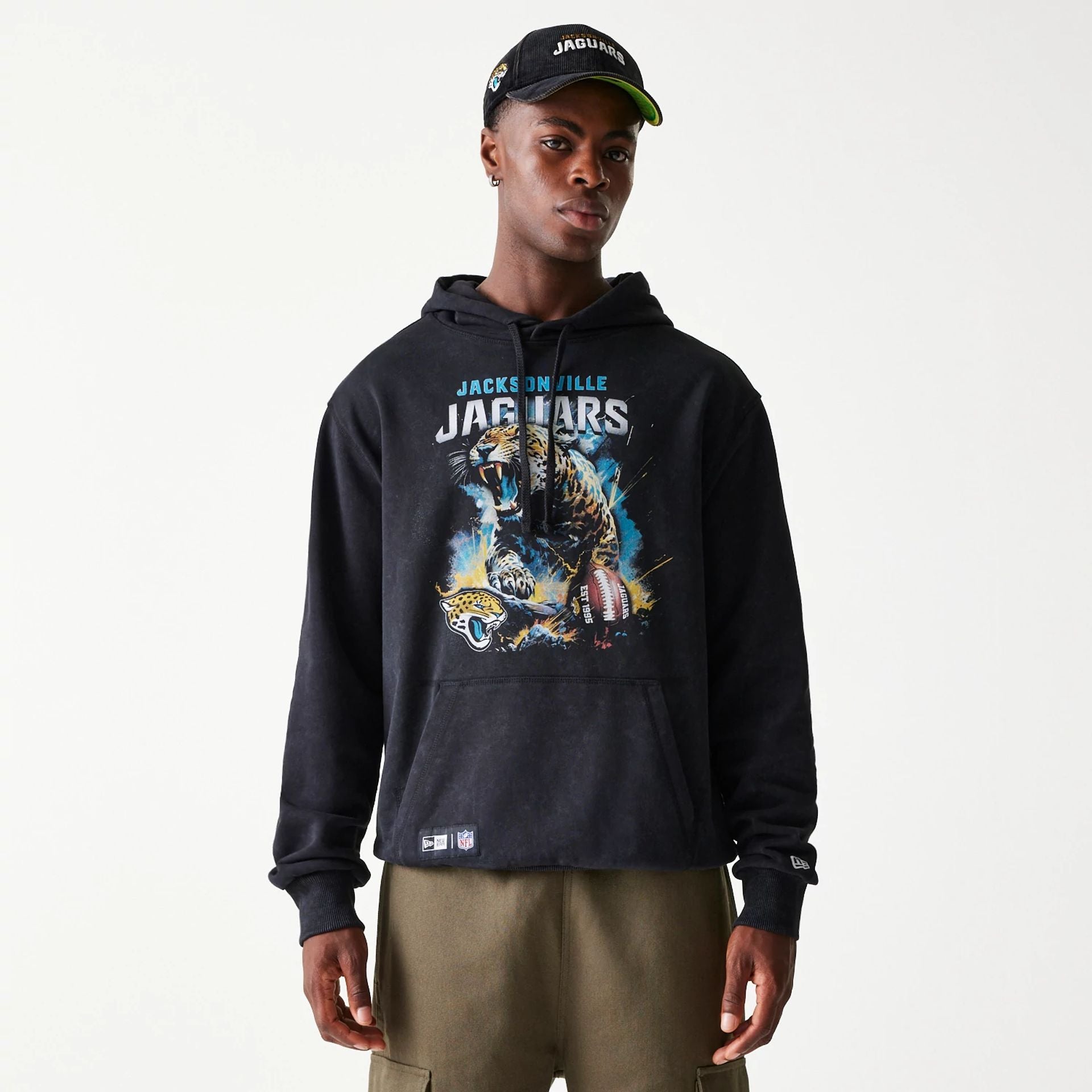 The Male model is wearing Jacksonville Jaguars NFL Games Premium Apparel Black Oversized Pullover Hoodie 1