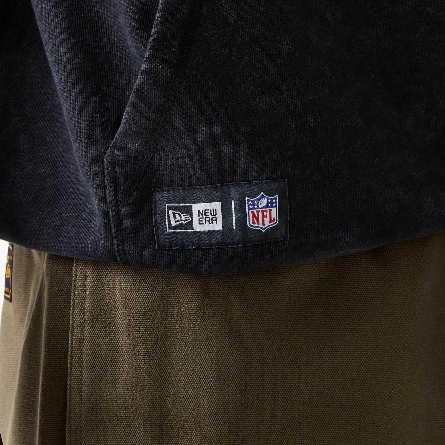 The Male model is wearing New York Giants NFL Games Premium Apparel Black Oversized Pullover Hoodie 3