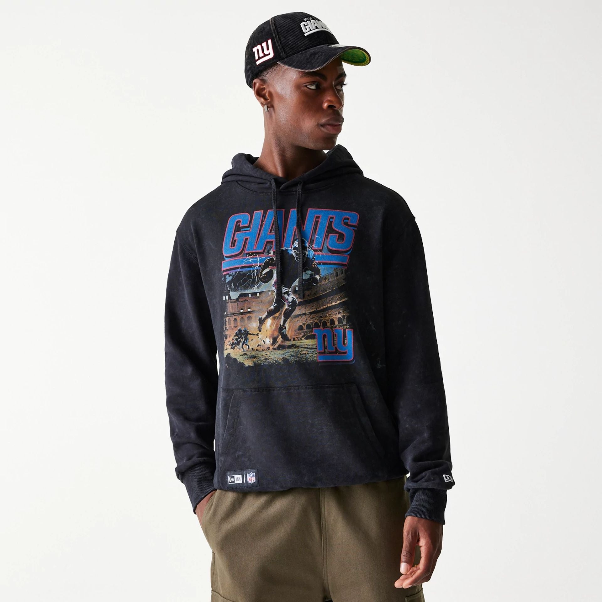 The Male model is wearing New York Giants NFL Games Premium Apparel Black Oversized Pullover Hoodie 1